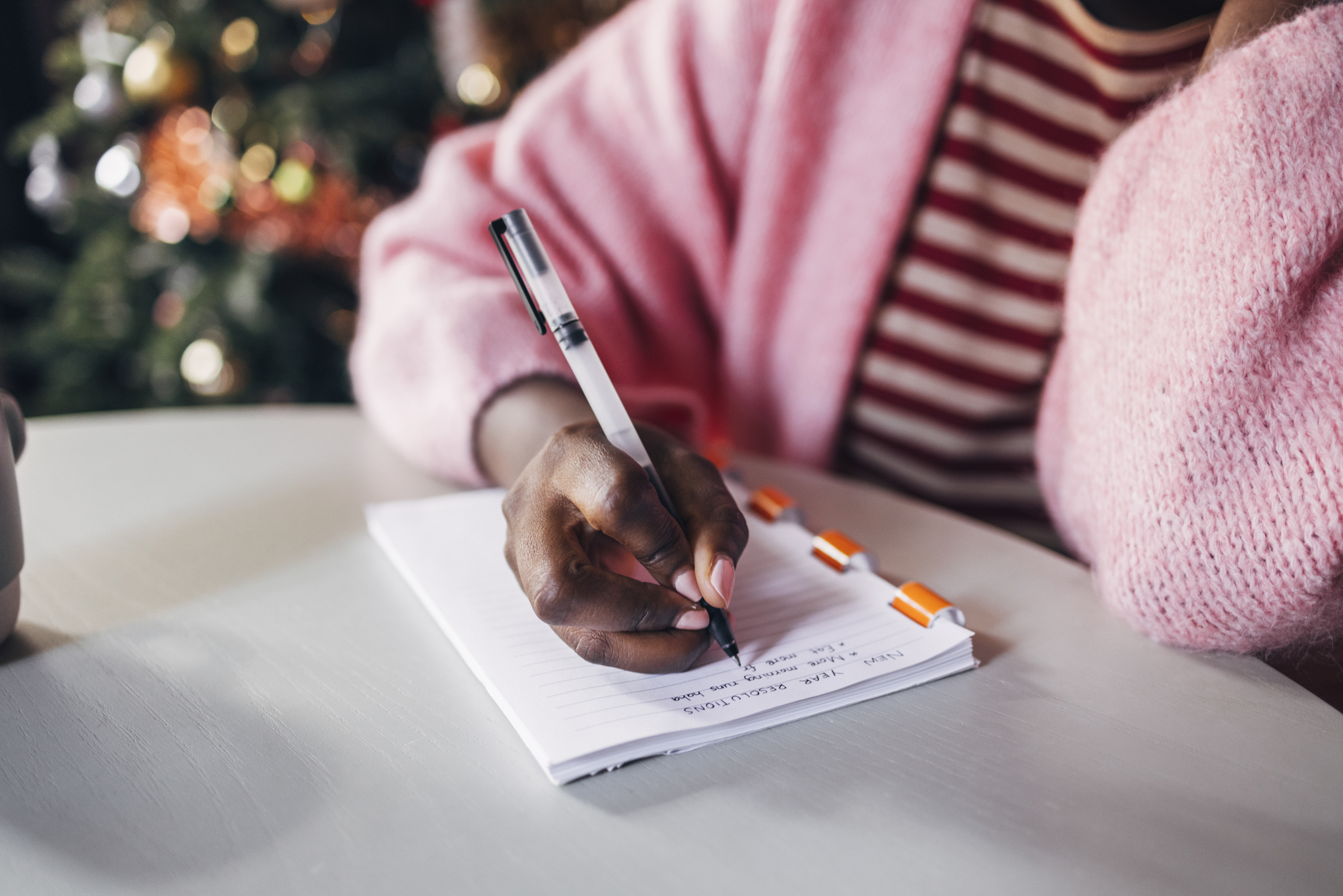 A woman writing in a notepad