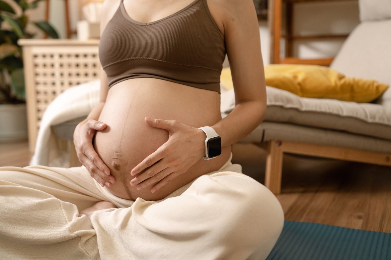 Pregnant woman practicing yoga and doing meditation.