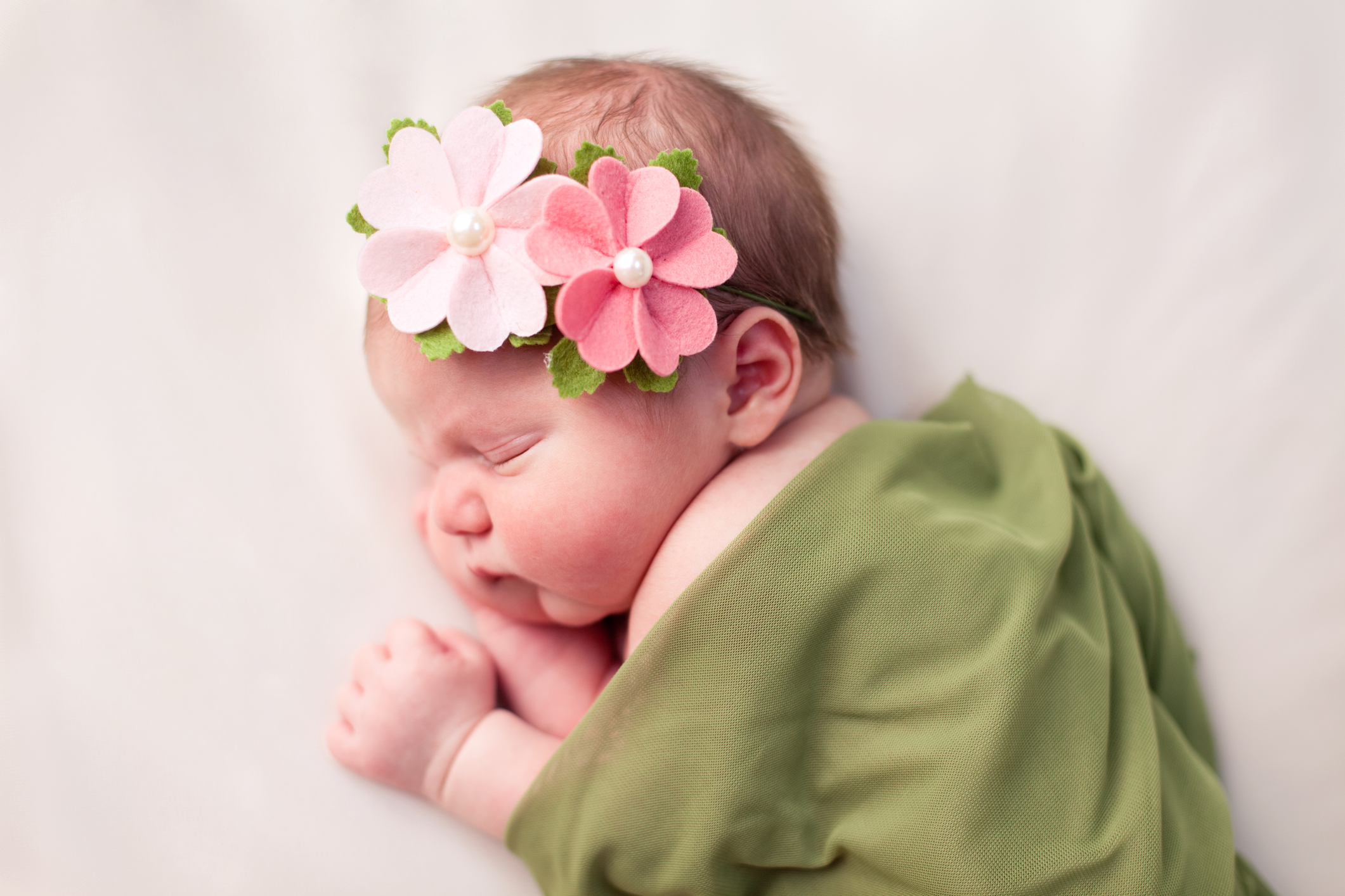 Newborn Baby Girl Swaddled in Soft, Green Blanket