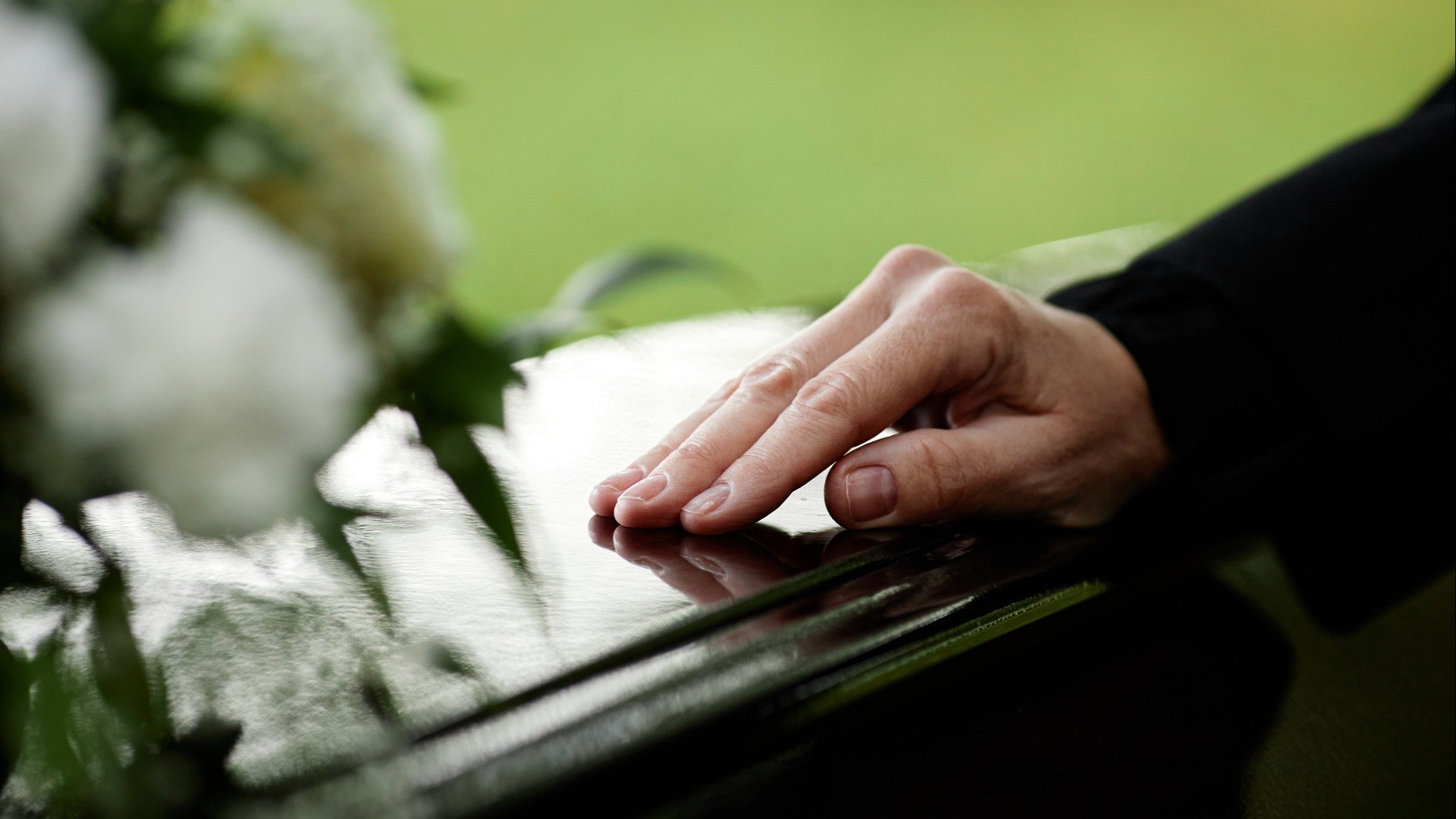 Someone touching a casket