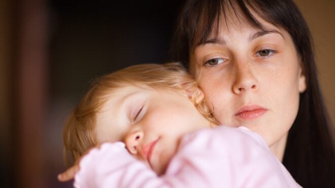 A mom holding a sleeping child
