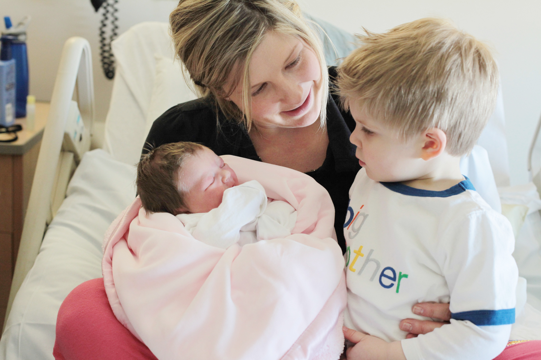 mom newborn toddler in hospital