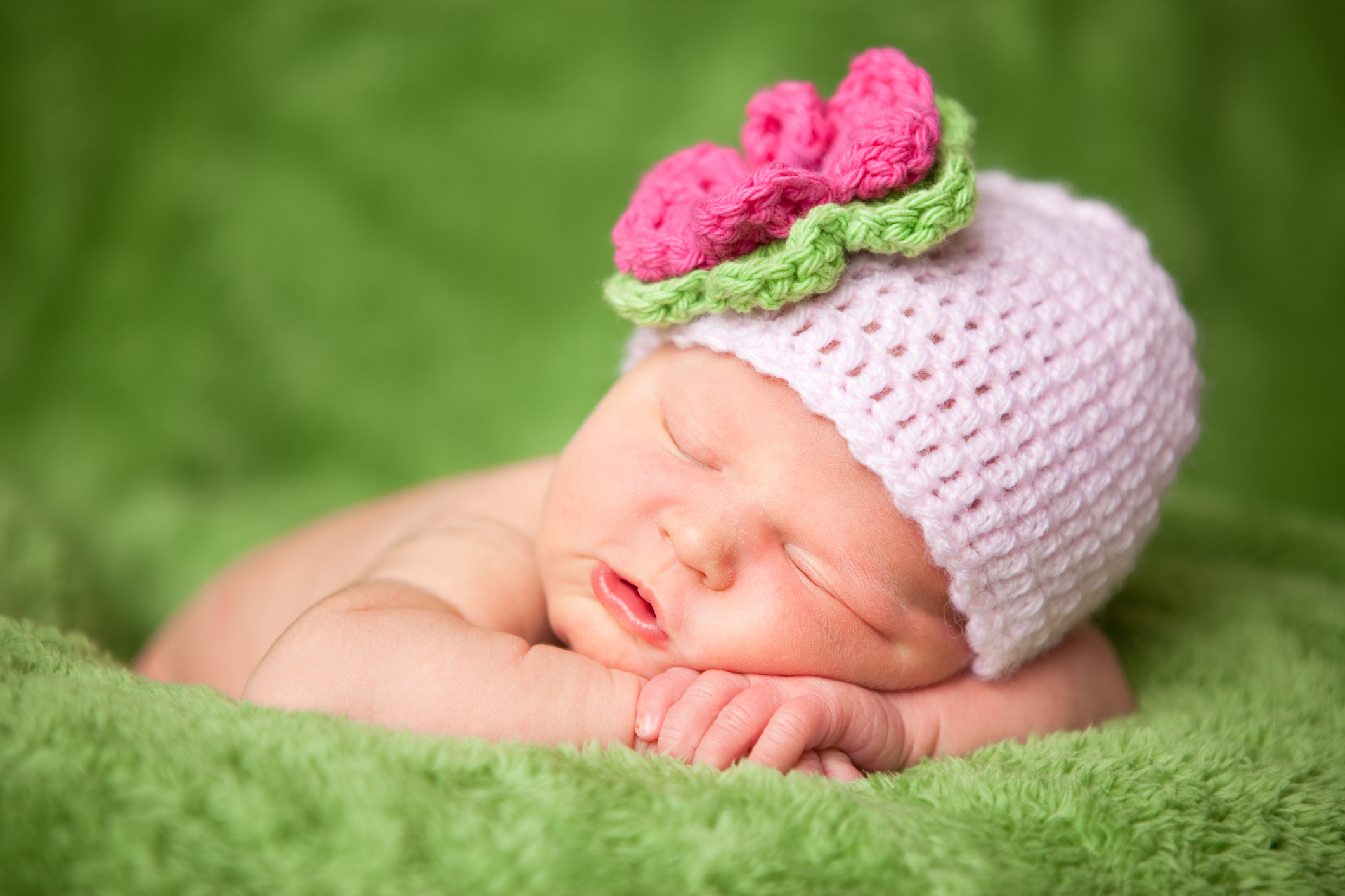Sleeping Newborn Baby Girl Wearing Knit Hat with Flower