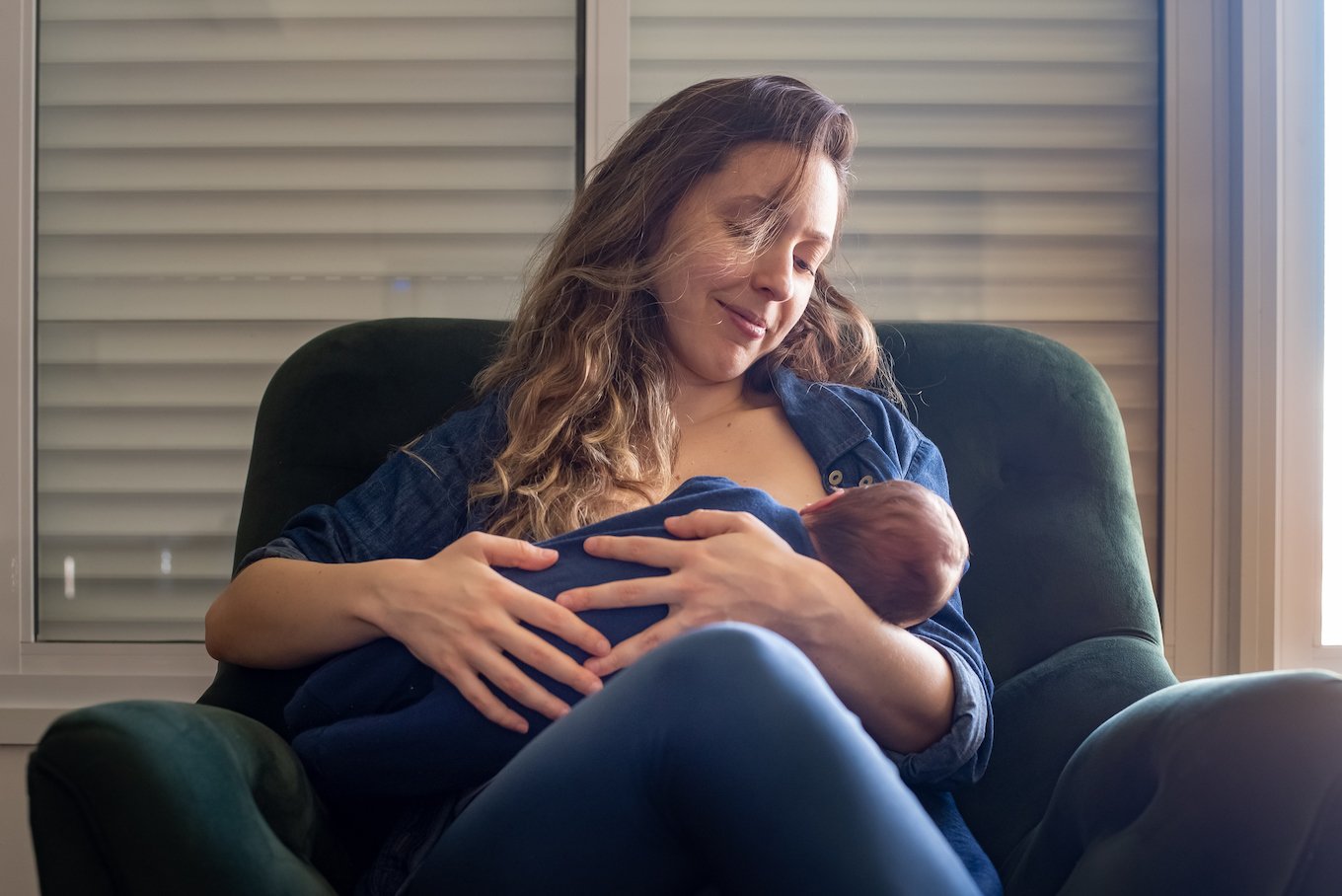 Mother breastfeeding newborn son