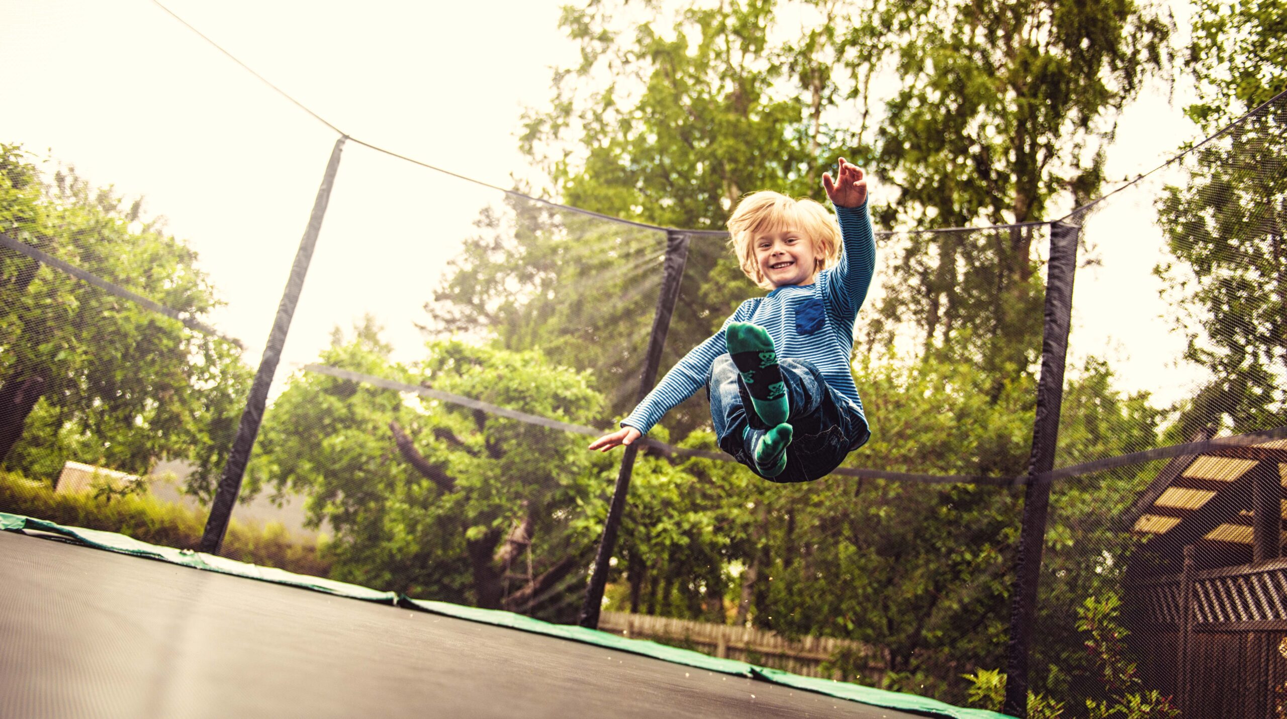 Boy jumping on a trampoline