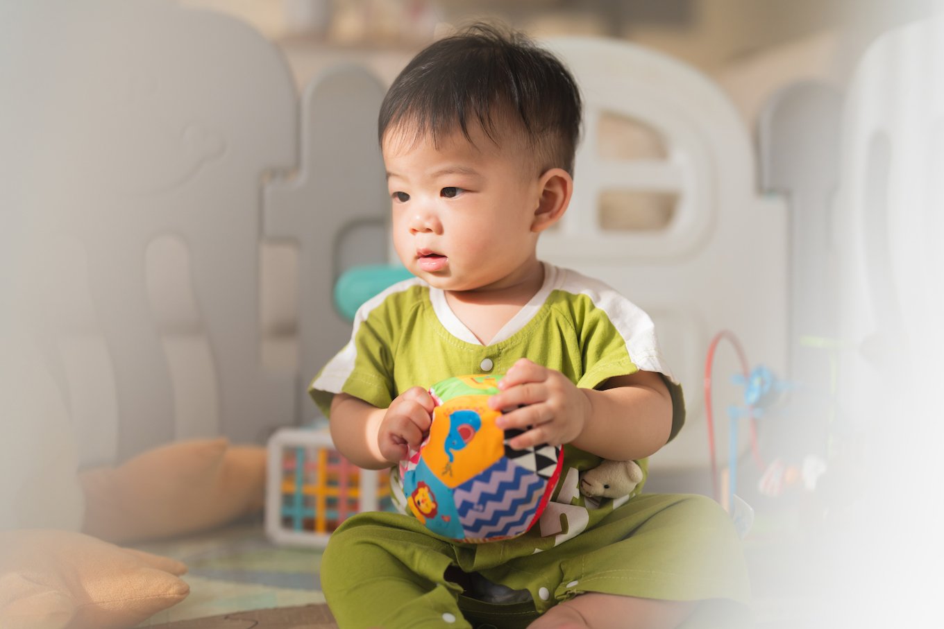 Asian family concept Little baby boy playing on the foam mat floor with toy block in crib.asian family child stay home lifestlye