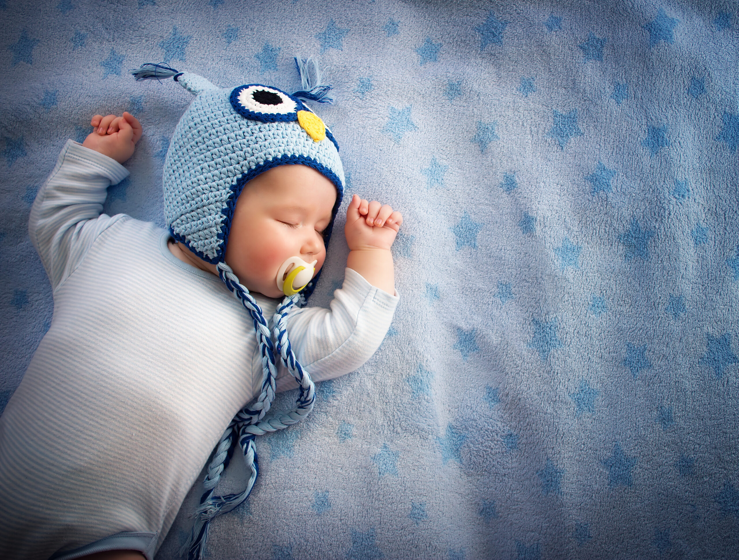 baby in owl hat sleeping