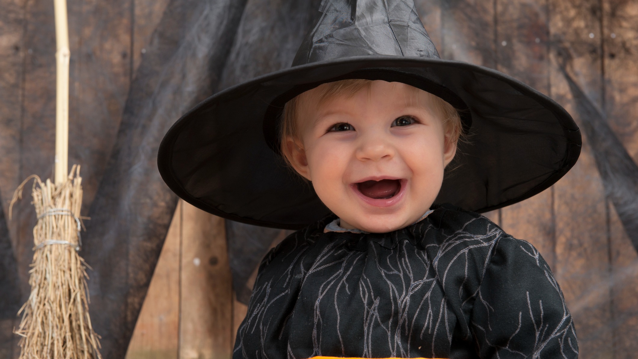 A baby in a witch costume