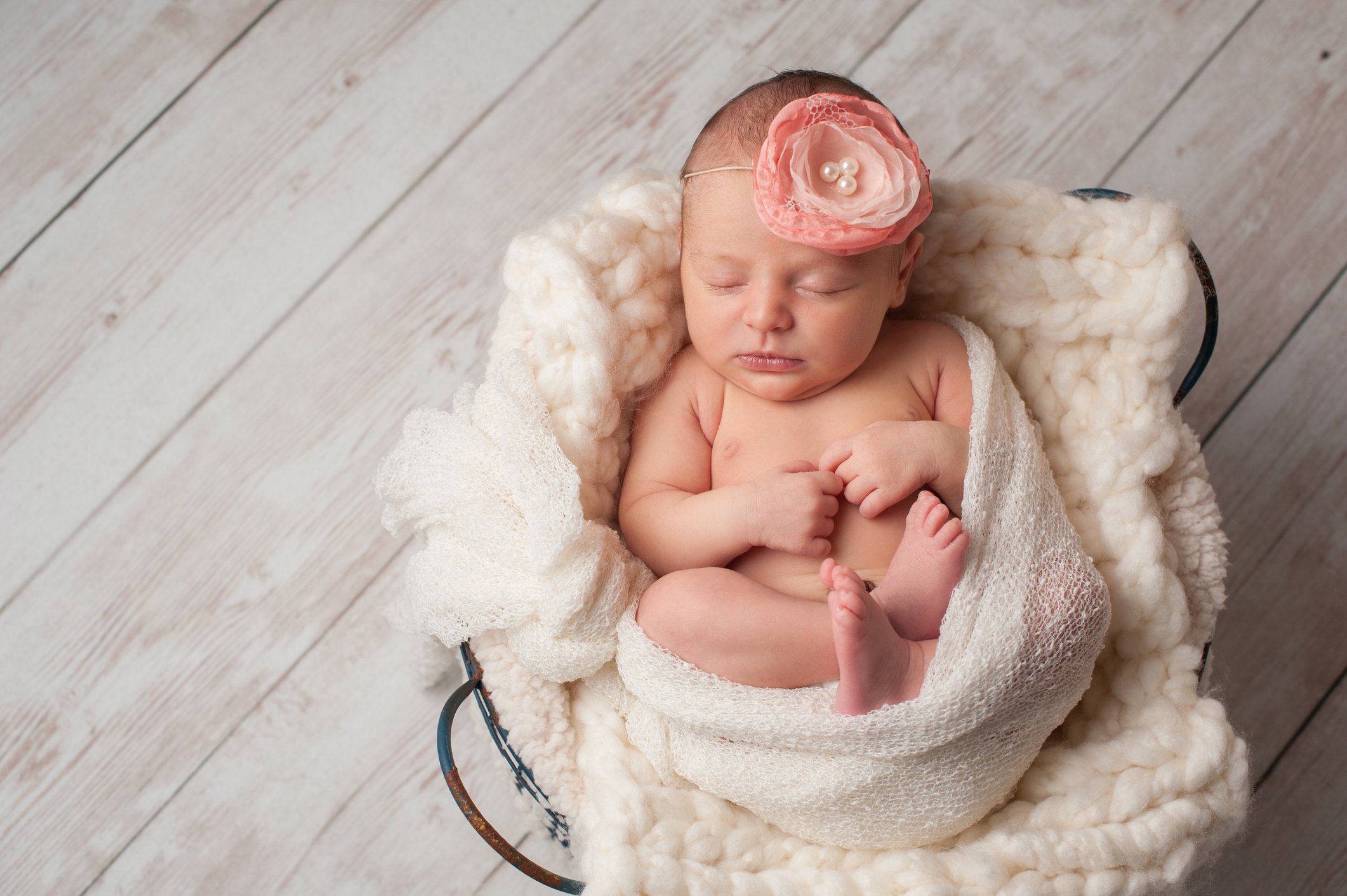 Newborn Baby Girl Wearing a Flower Headband