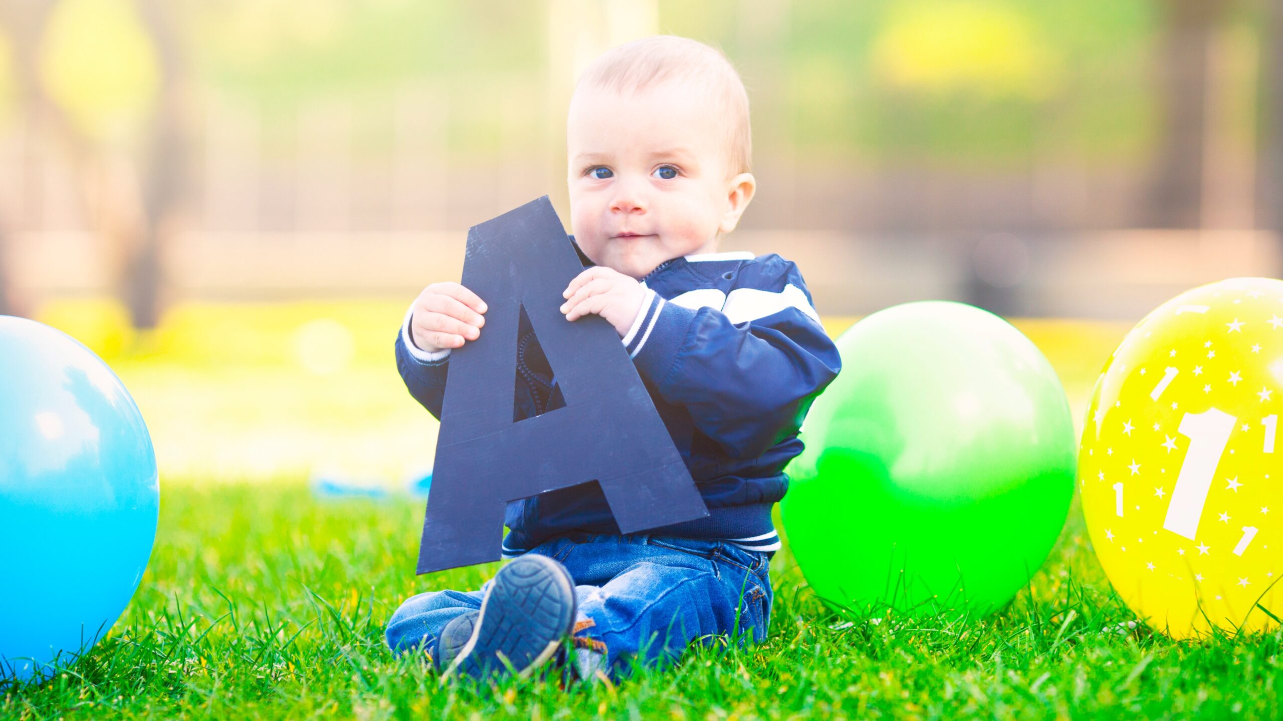 baby boy holding letter A