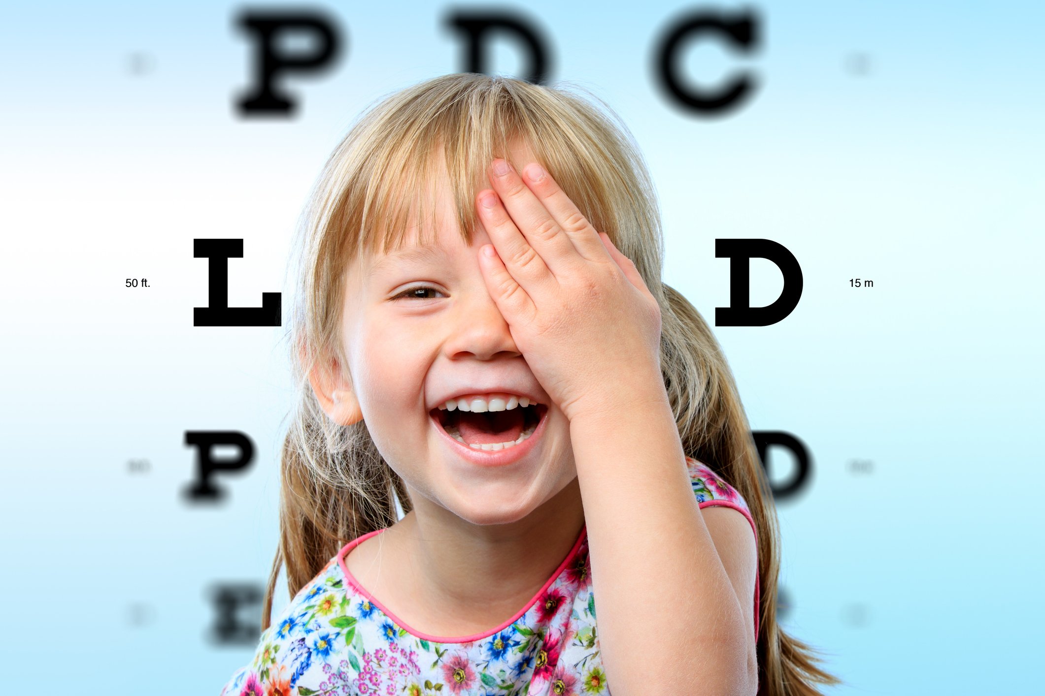 A kid doing an eye exam