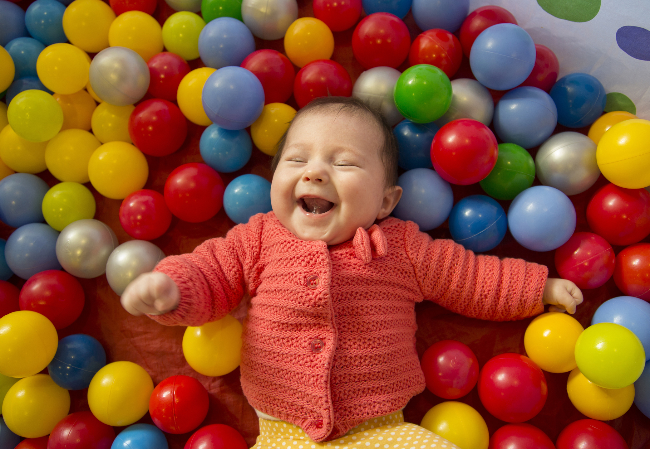 baby girl in a ball pit