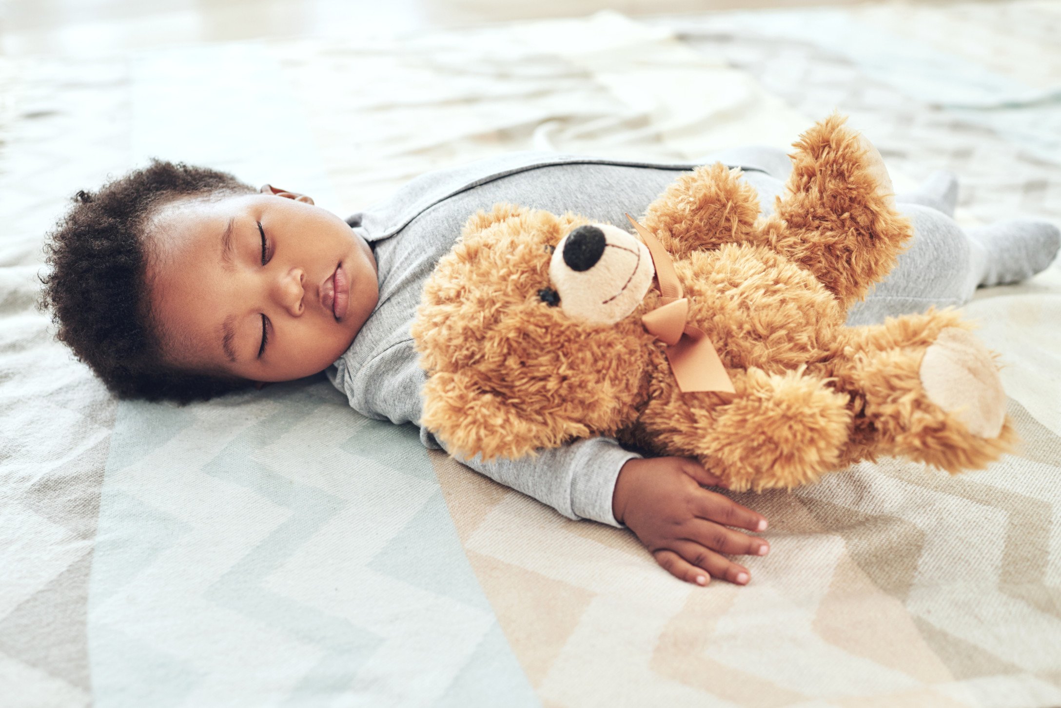 baby sleeping with teddy bear