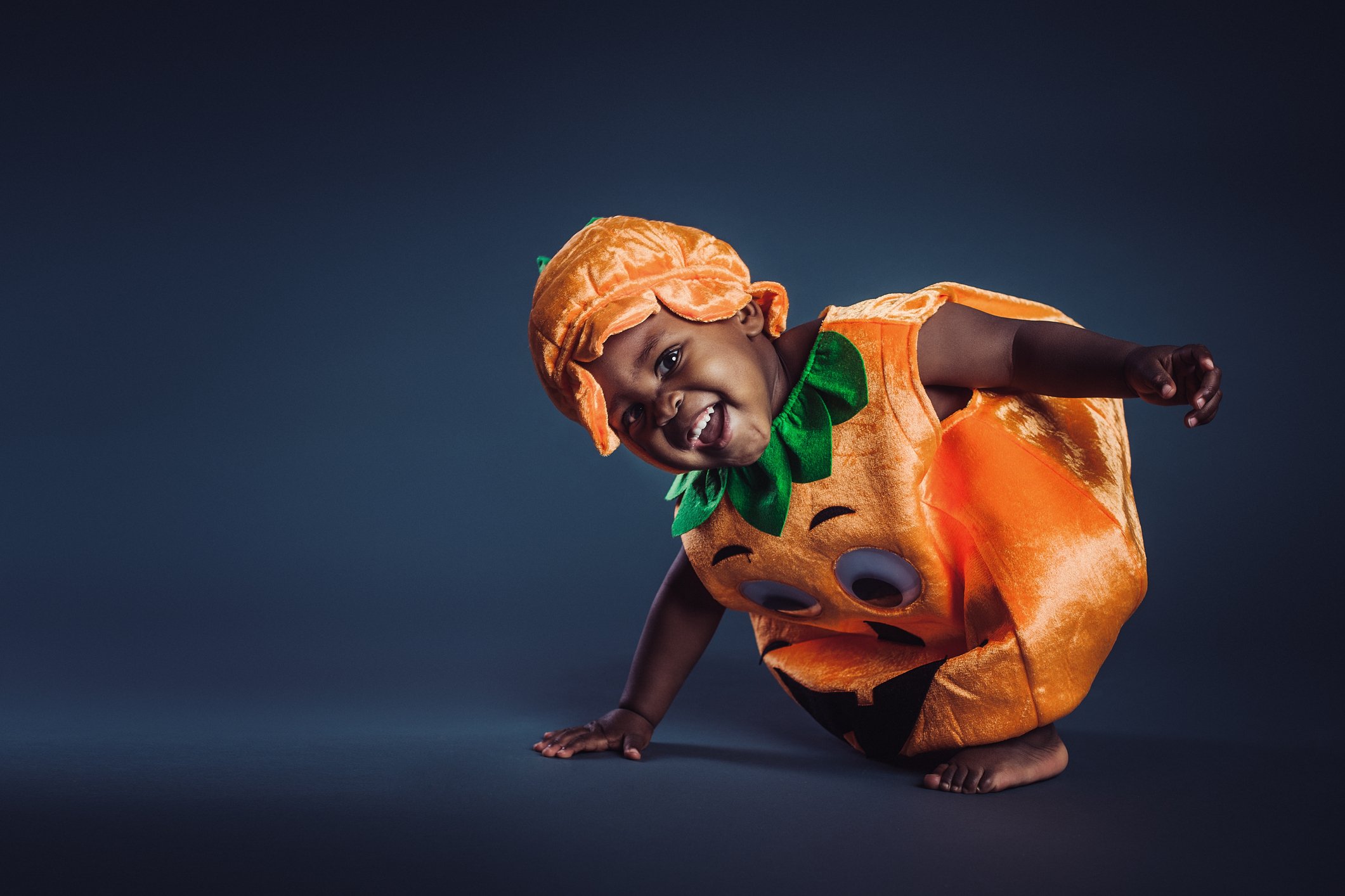Cute baby boy in pumpkin costume