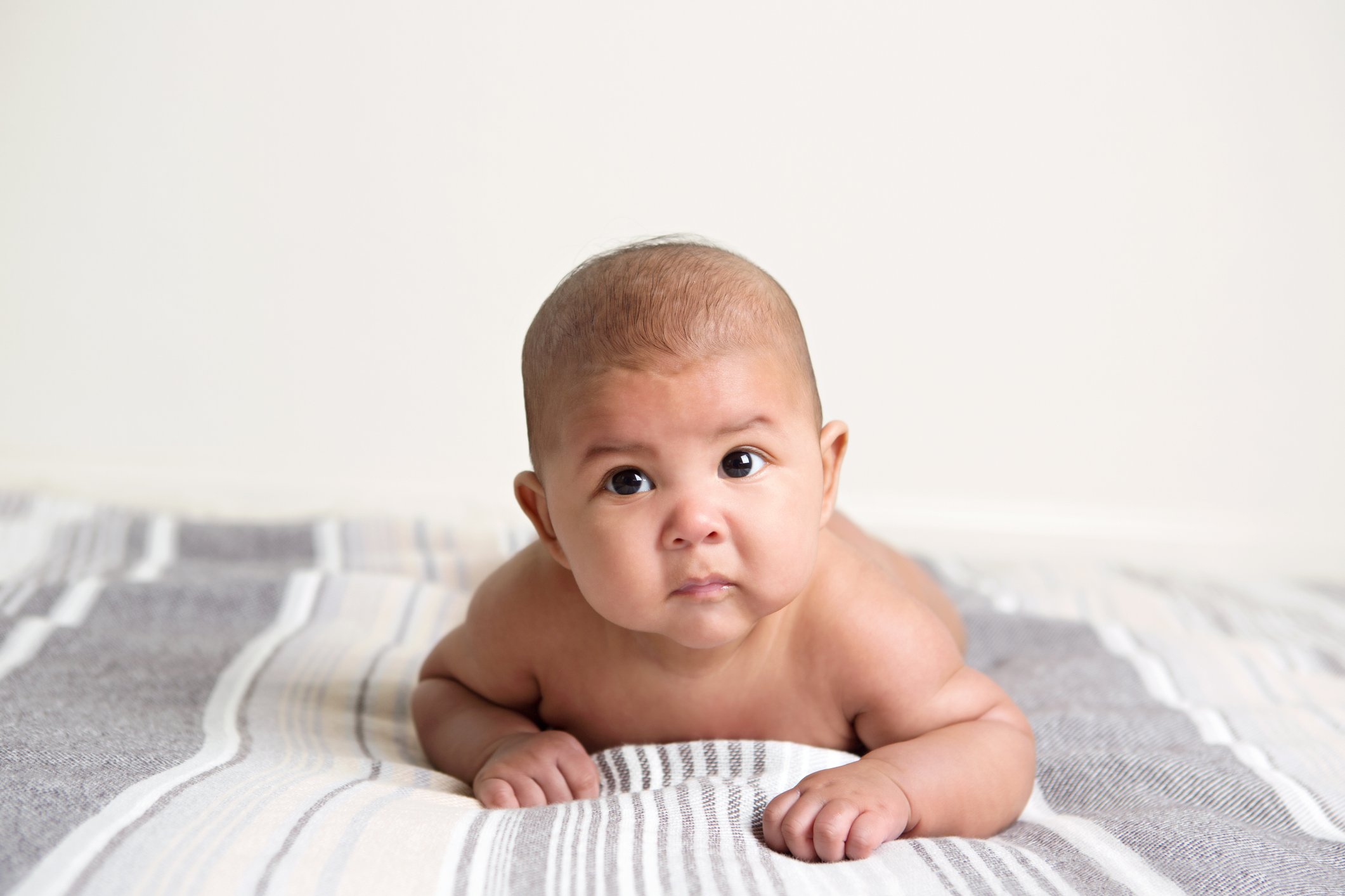 Multi Ethnic Handsome 3 Month Baby Boy Lying On Tummy