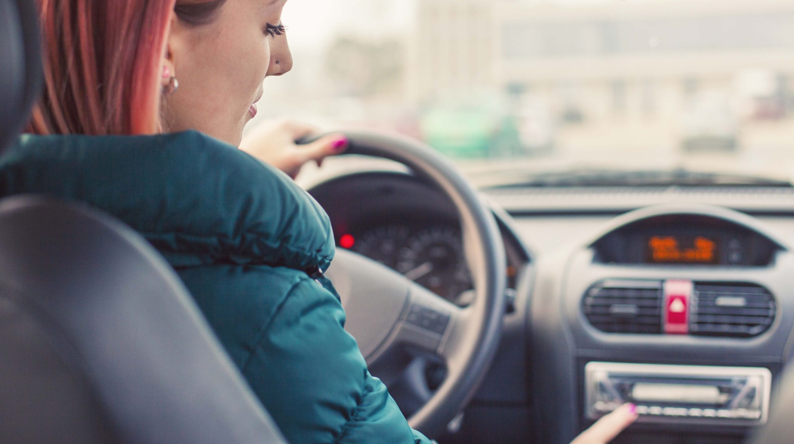 Young driver changing radio stations