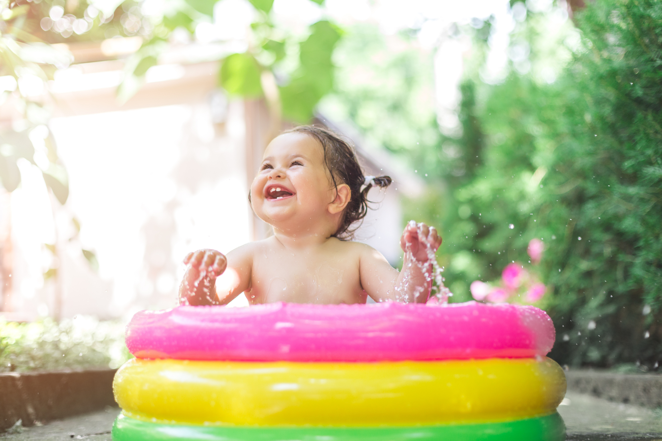 one year old baby playing in baby pool