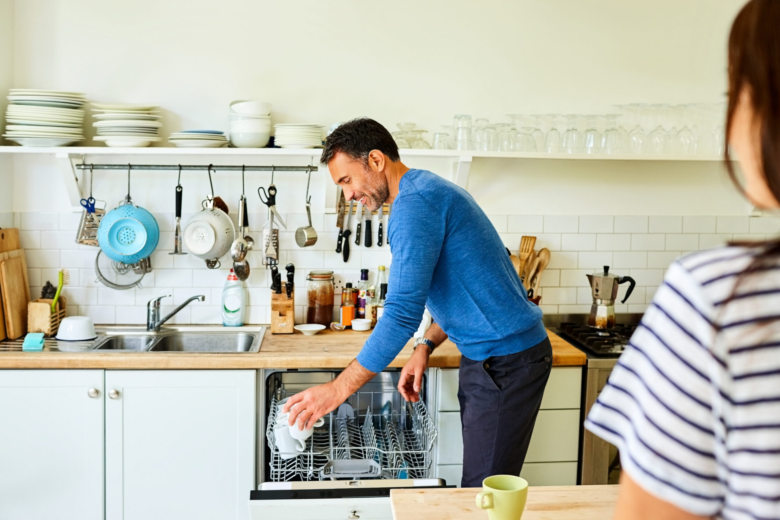 man unloading dishwasher