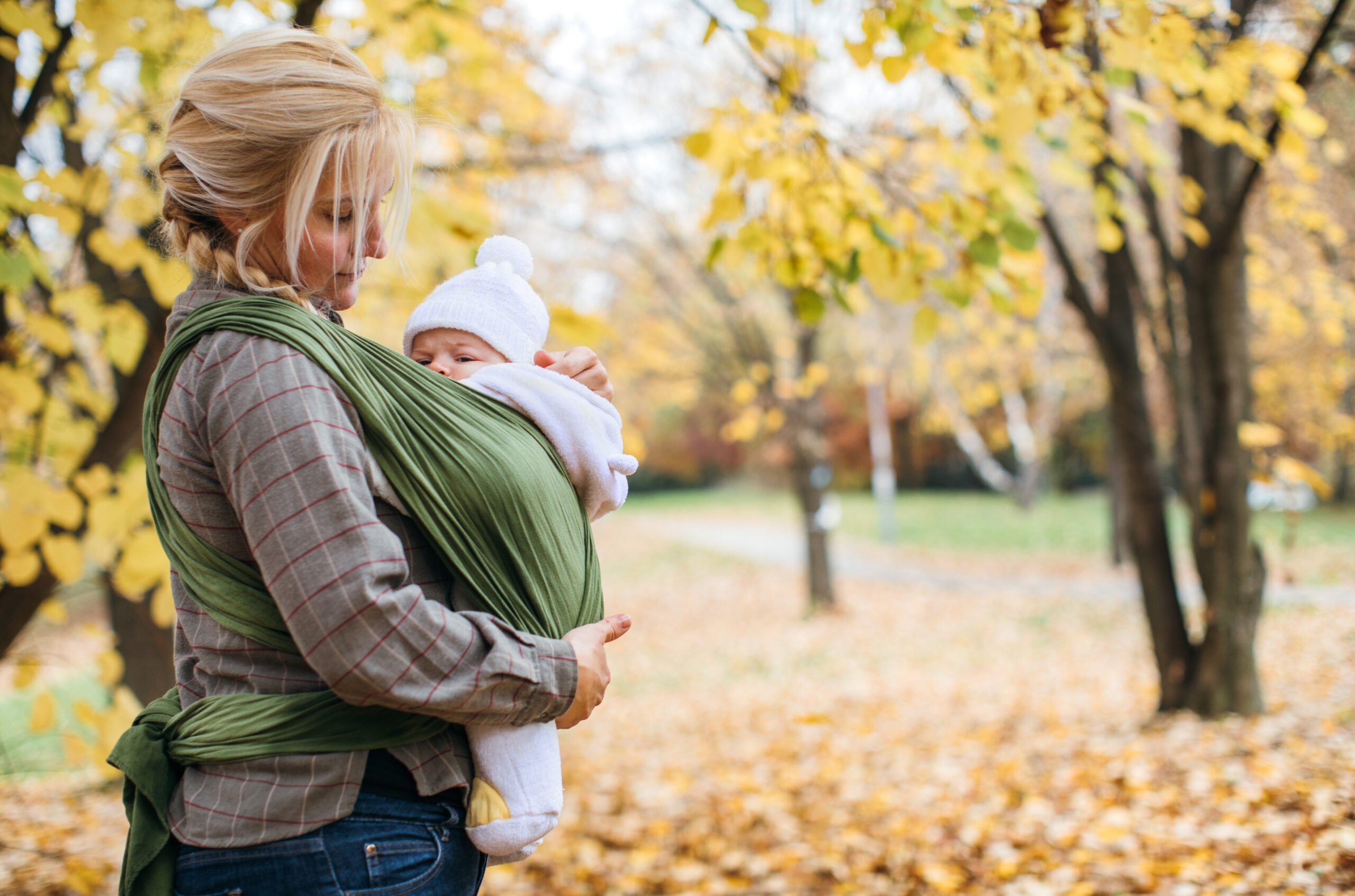 Newborn in baby sling carrier