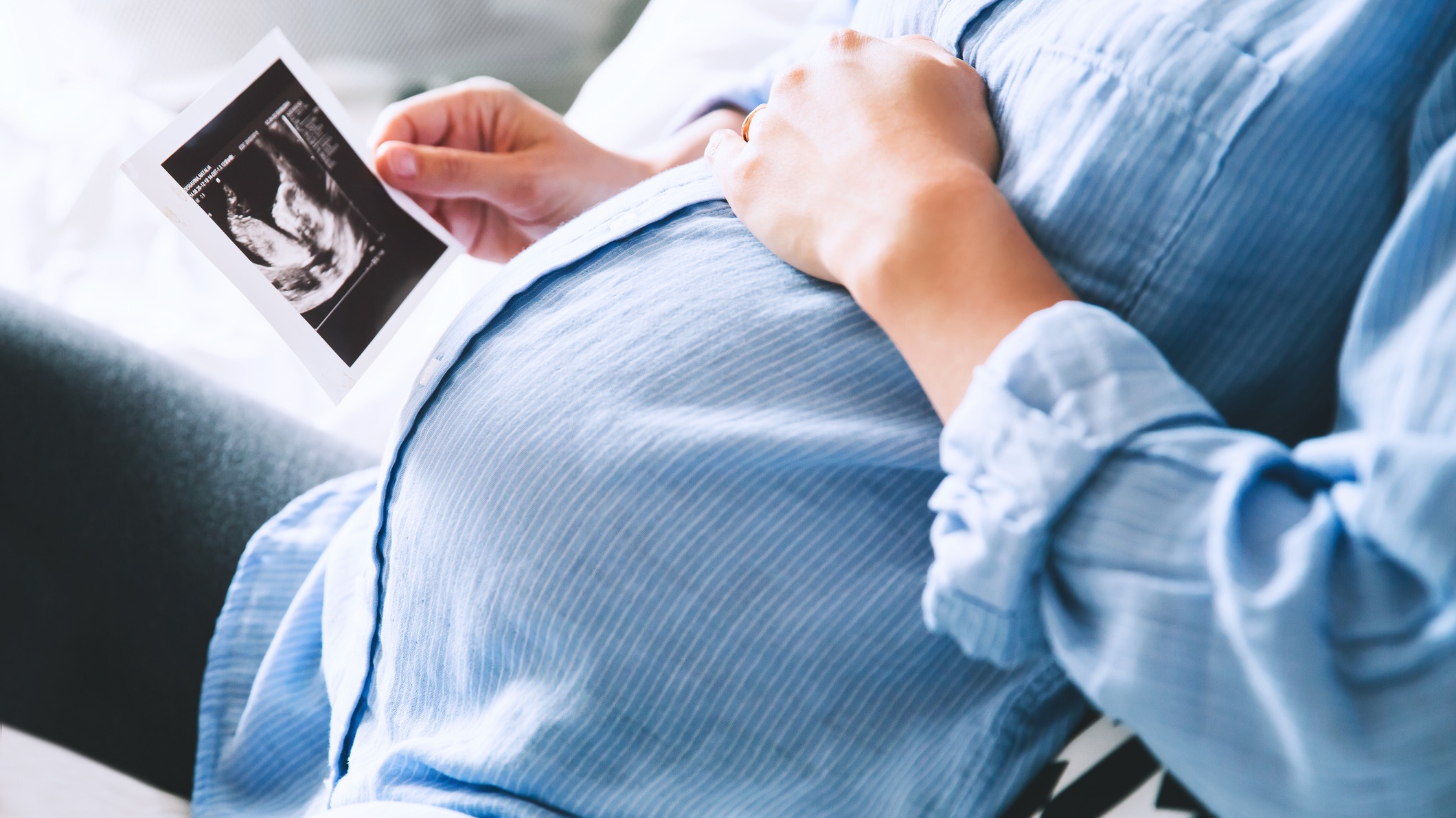 A pregnant woman looking at a sonogram