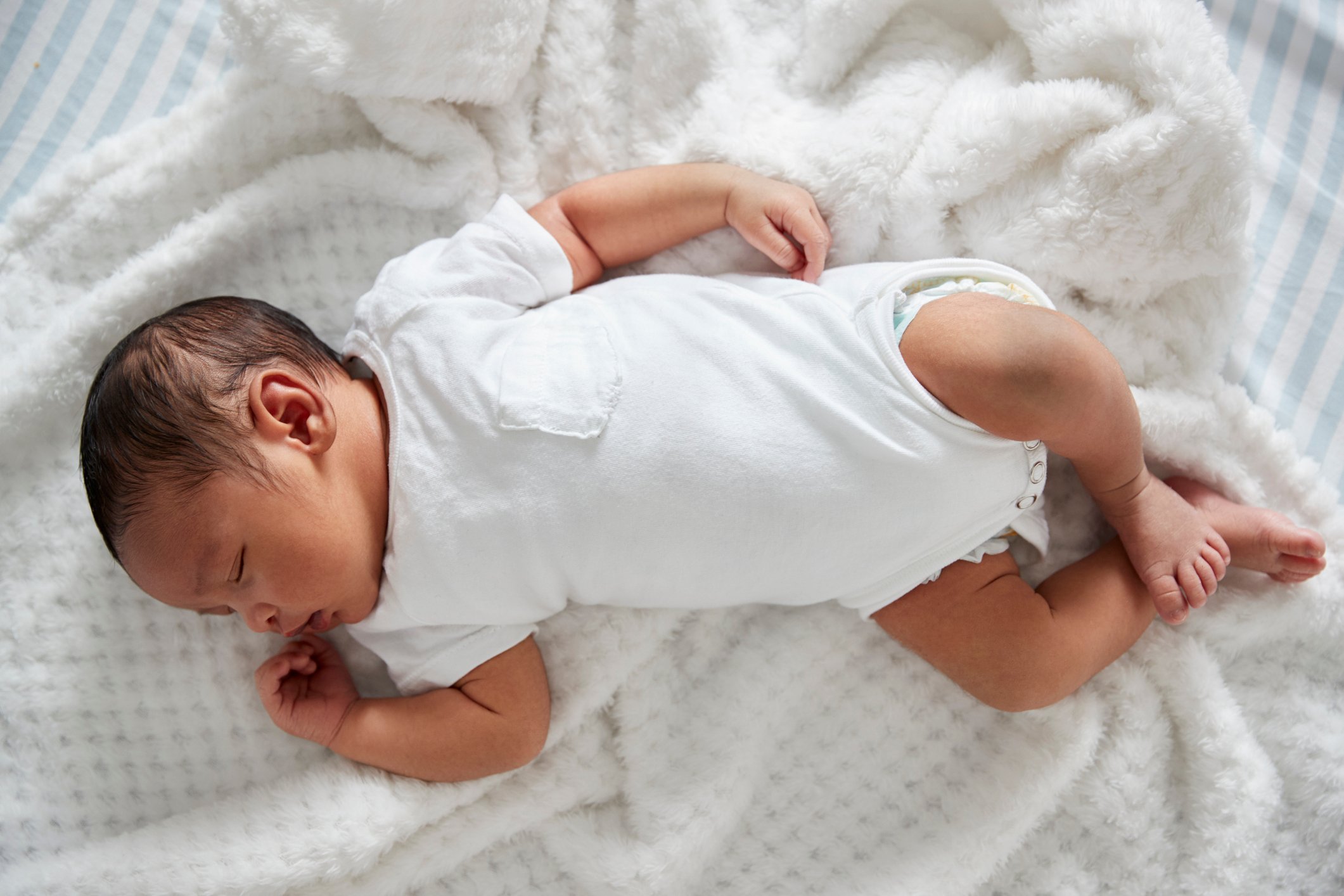 Newborn Baby Sleeping In Nursery Cot