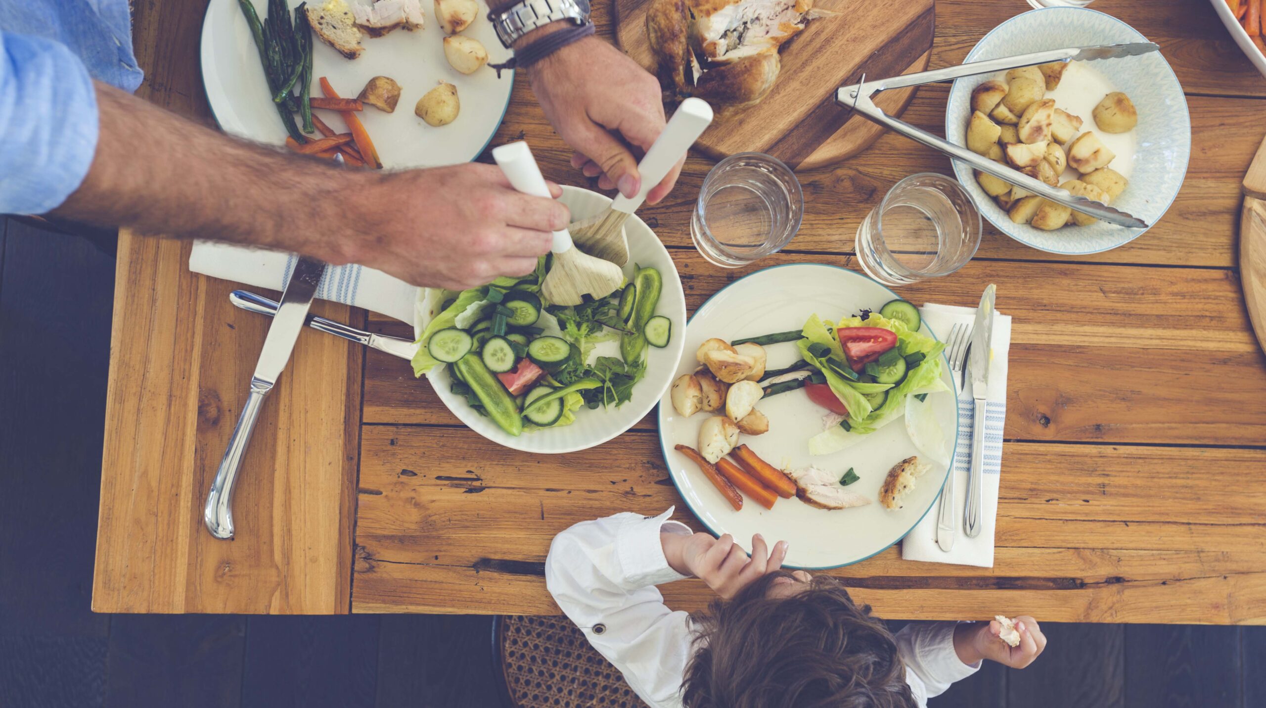 Father serving food to his son.