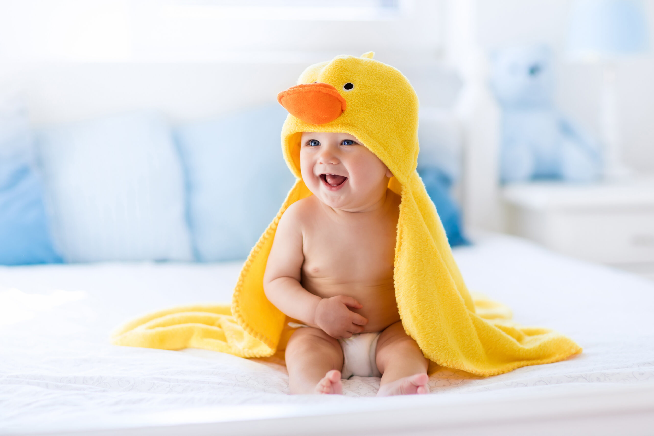 Cute baby after bath in yellow duck towel