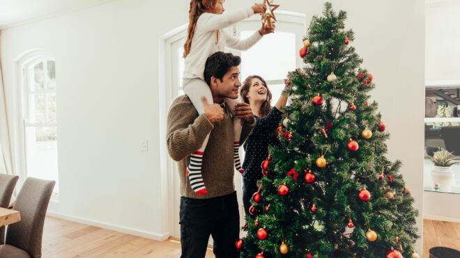 family decorating christmas tree