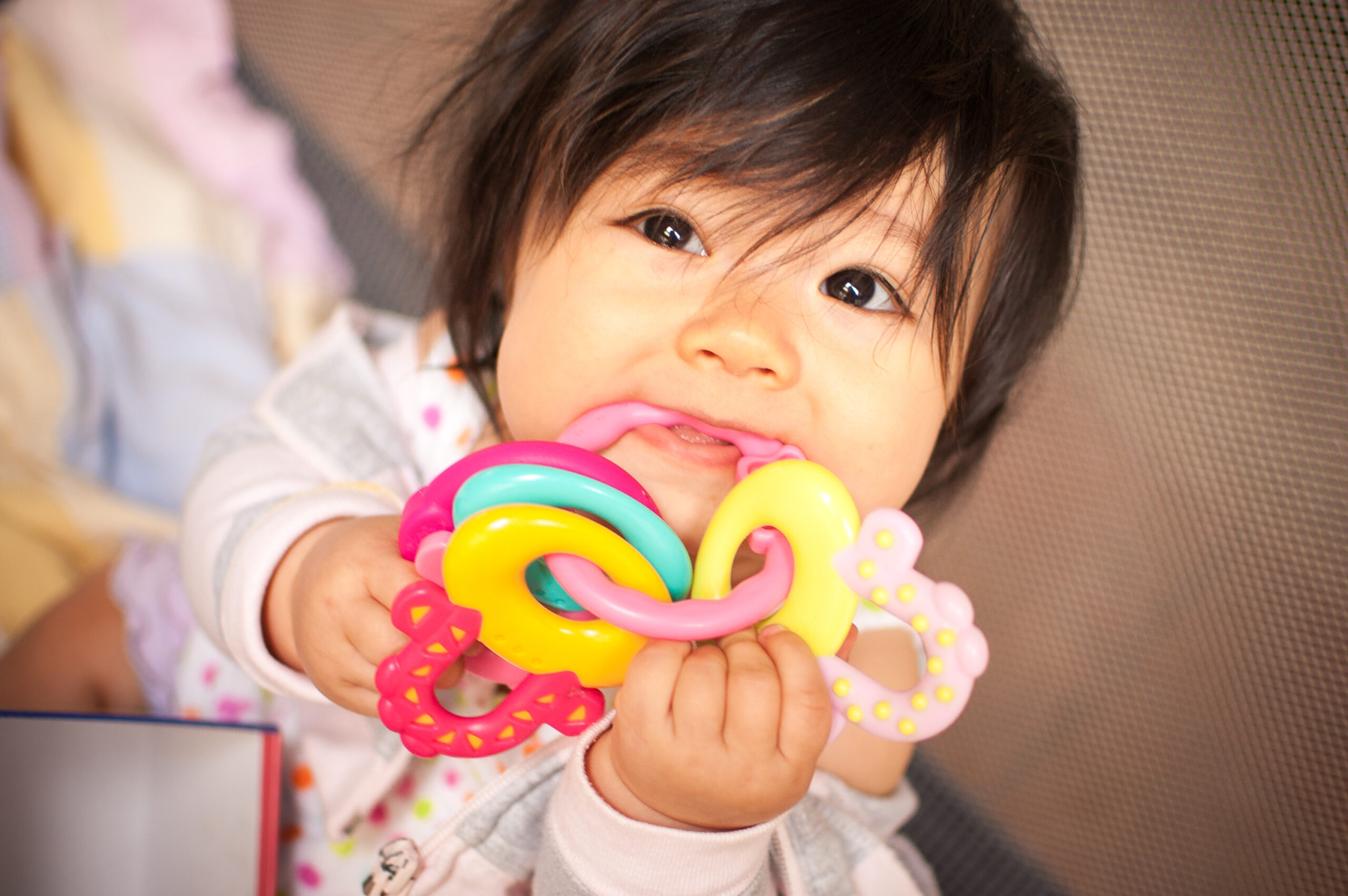Baby chewing on teething toy
