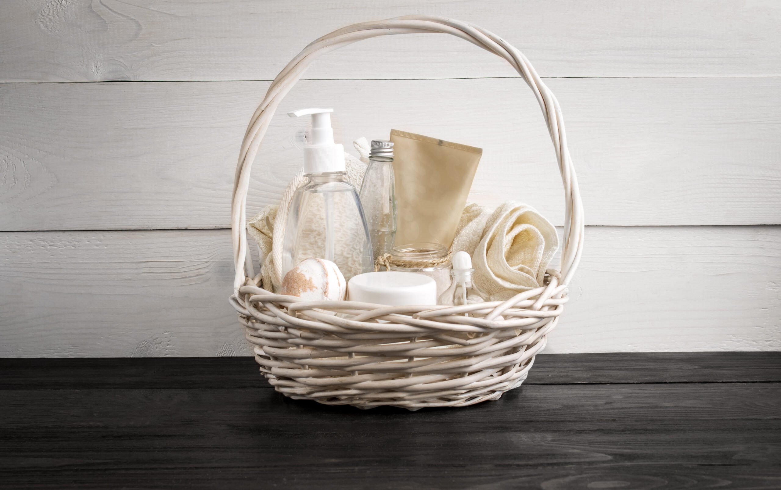 Wicker basket with spa treatments on table