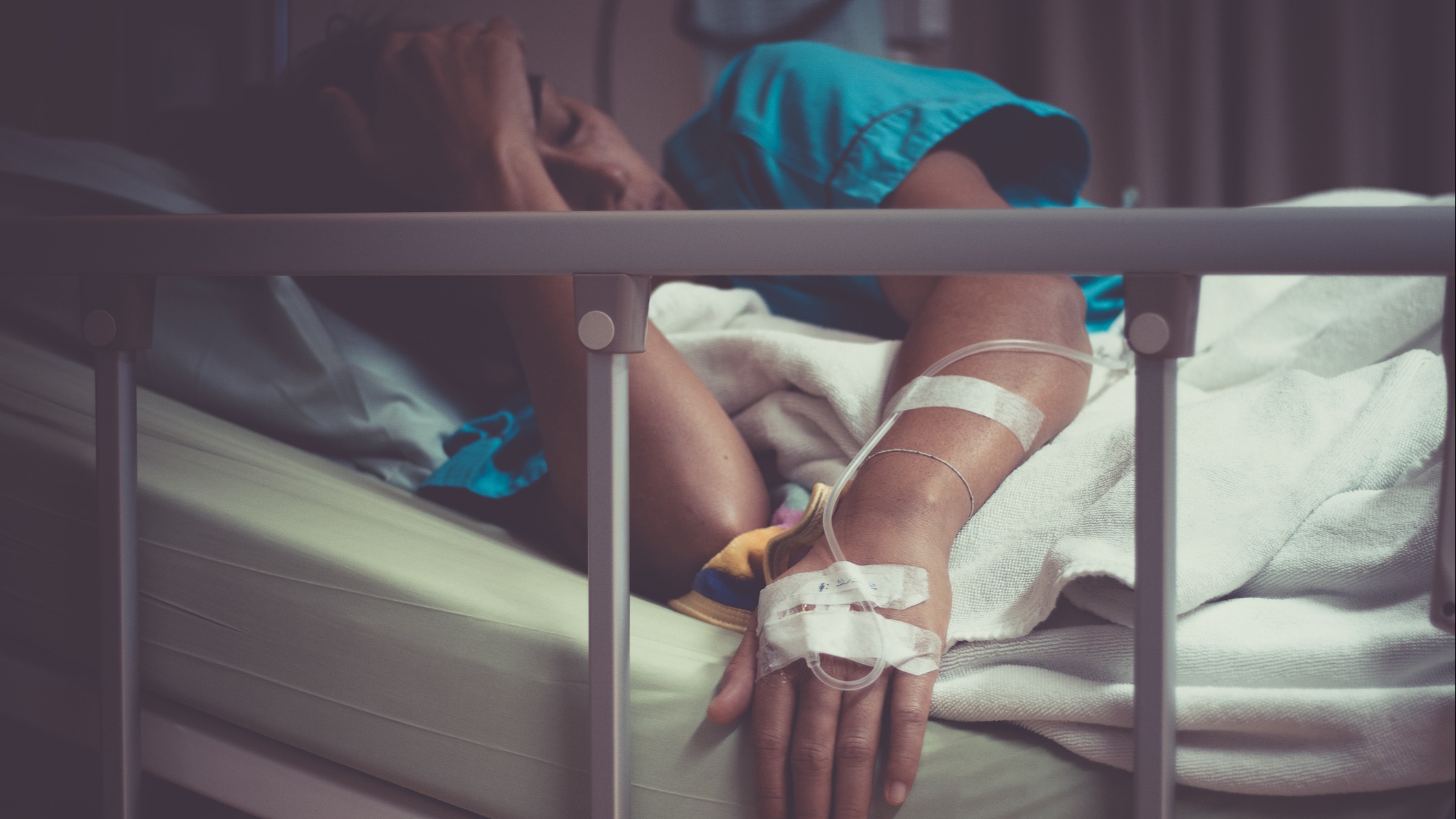 A sick woman in a hospital bed