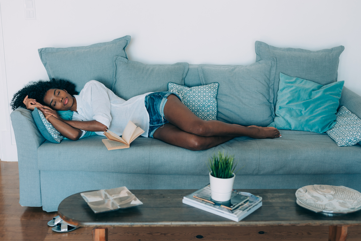 Beautiful black young woman sleeping in the sofa