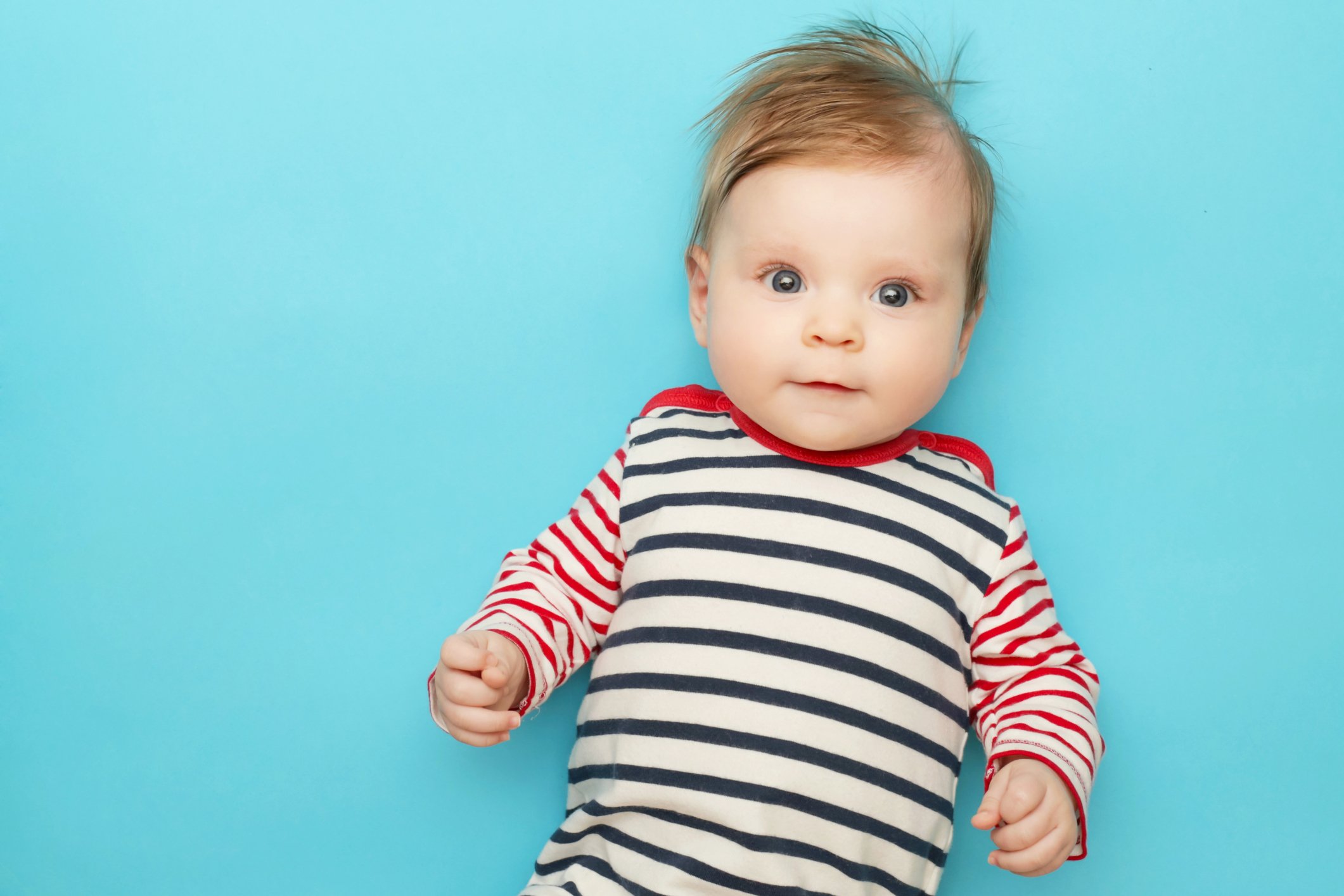 Adorable newborn portrait on the blue background, studio shot