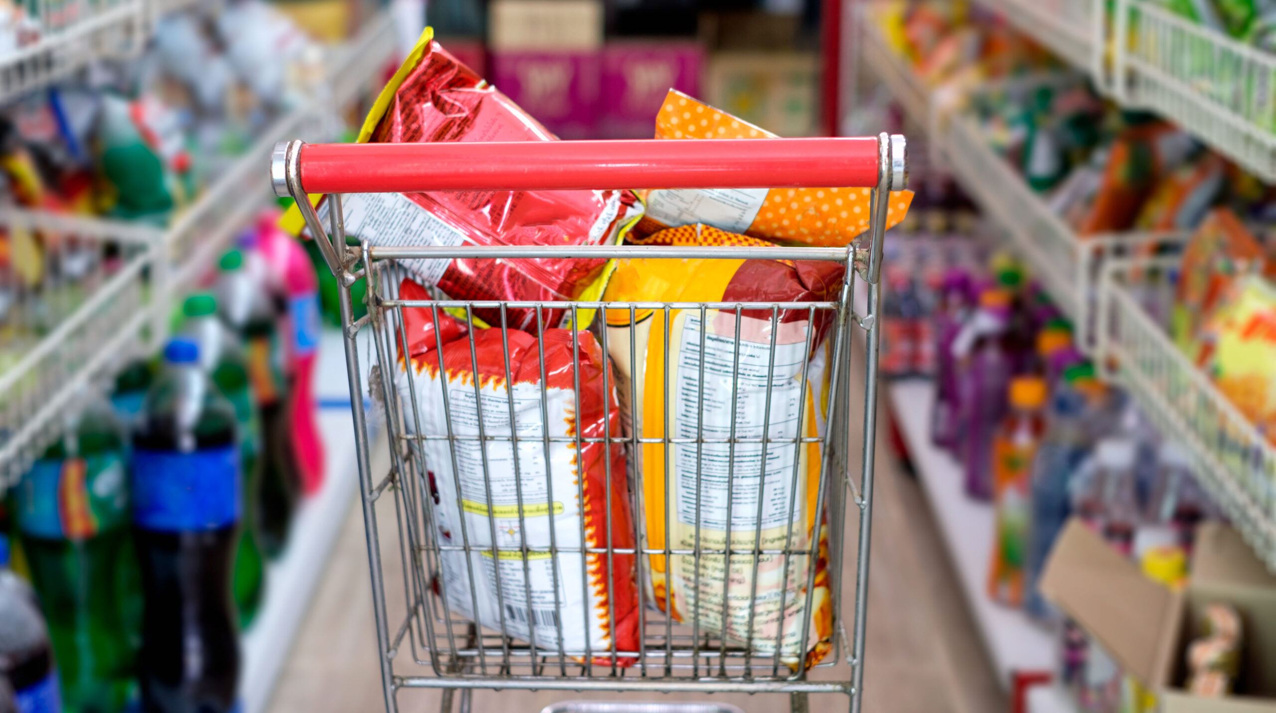 Snack packs in shopping cart at store