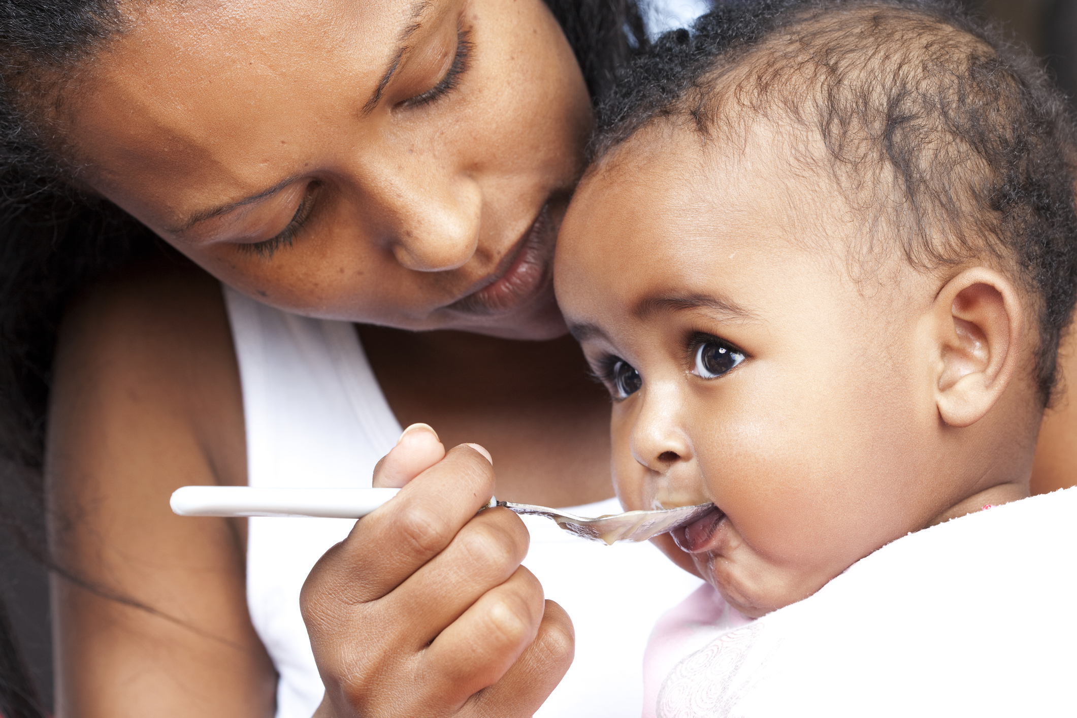 Mom feeding baby solid food