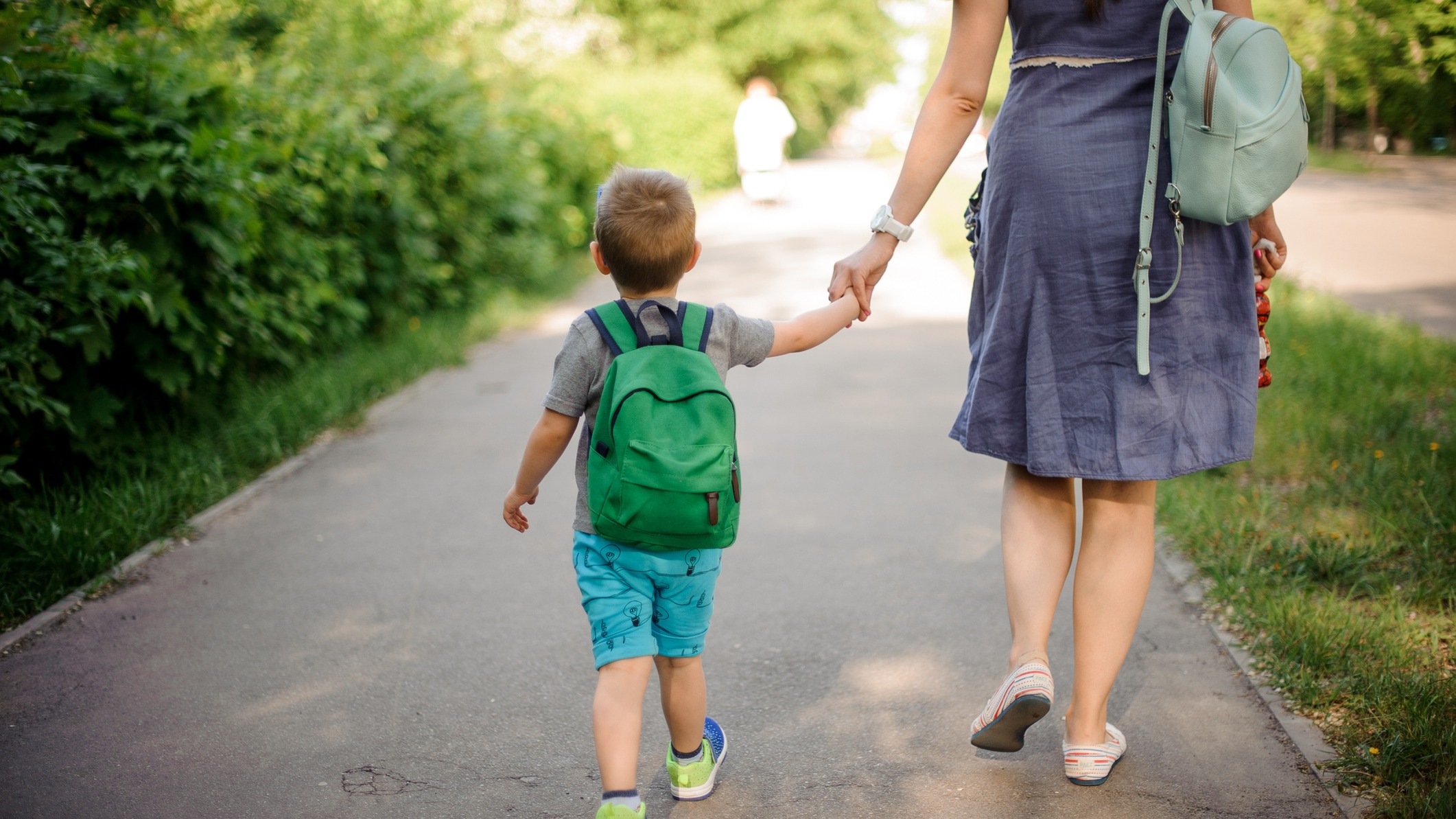 Little boy holding his mom's hand