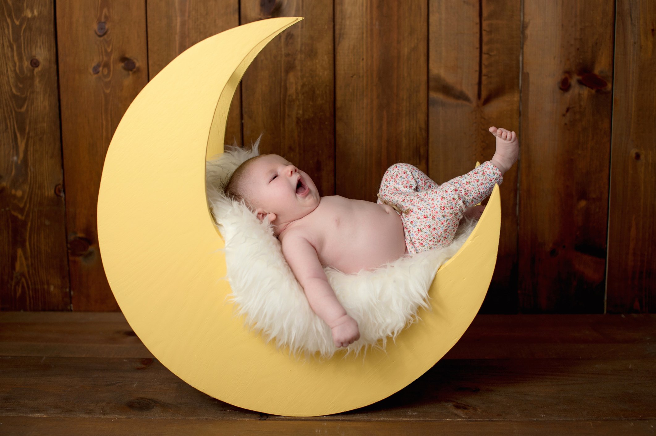 Baby Girl Lying on a Moon Shaped Photo Prop
