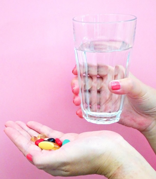 medications-womans-hand-holding-a-handful-of-colorful-pills-and-vitamins-with-a-glass-of-water_t20_W7ypkL.jpg