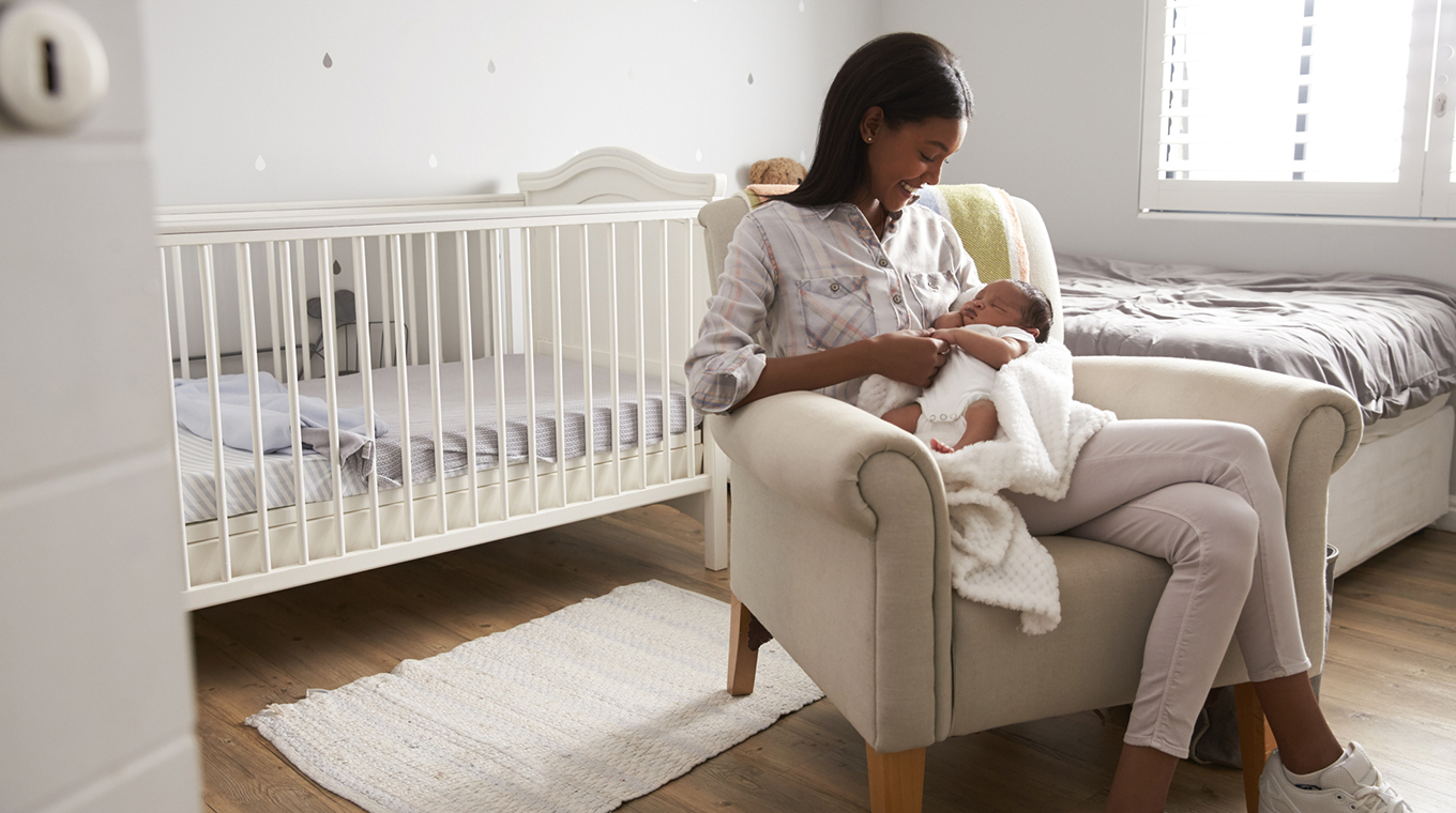 Mother Home from Hospital With Newborn Baby In Nursery