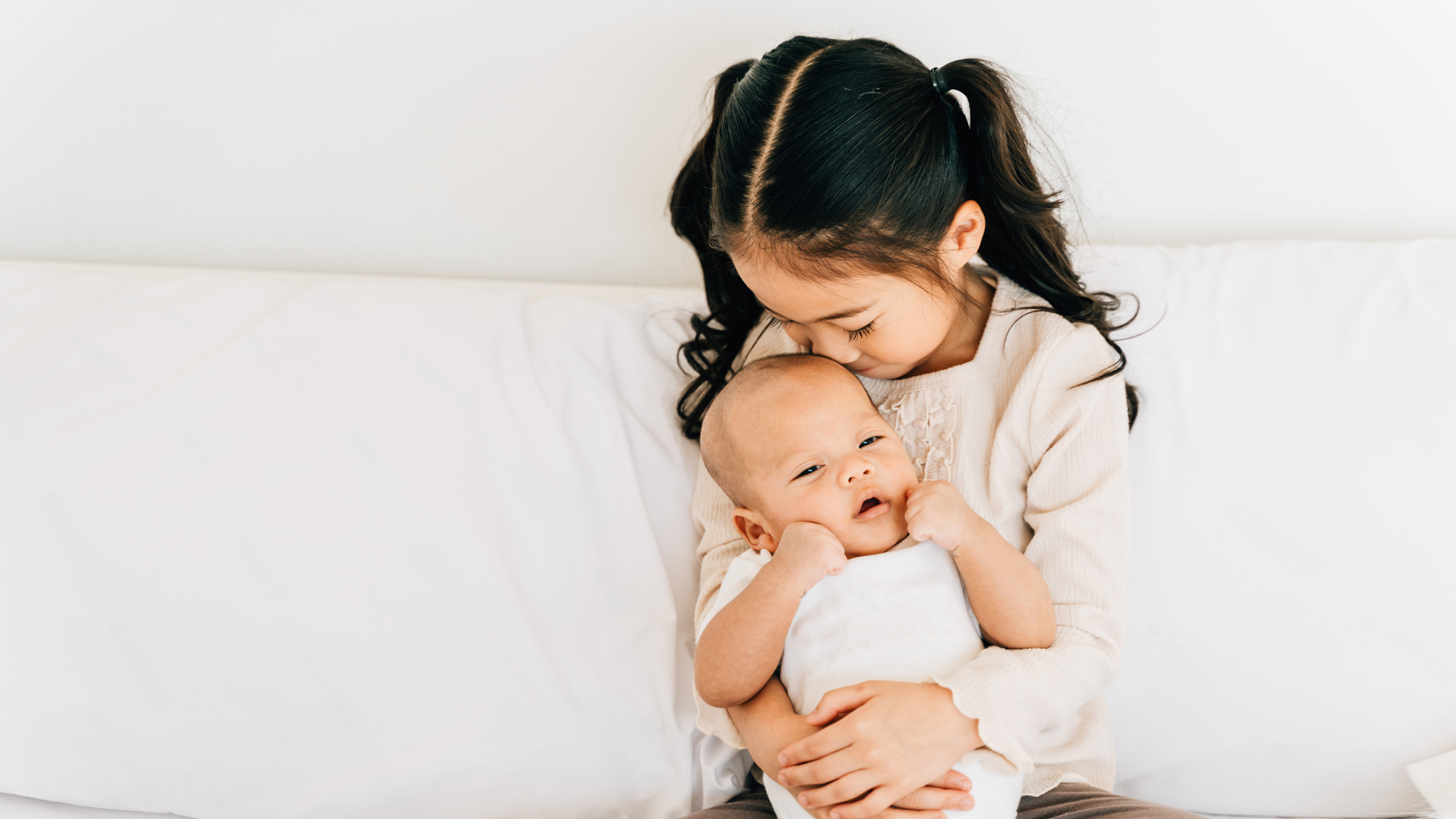 older siblings helping with baby