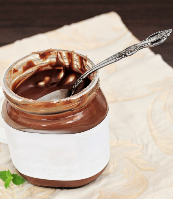 Chocolate cream in jar with spoon