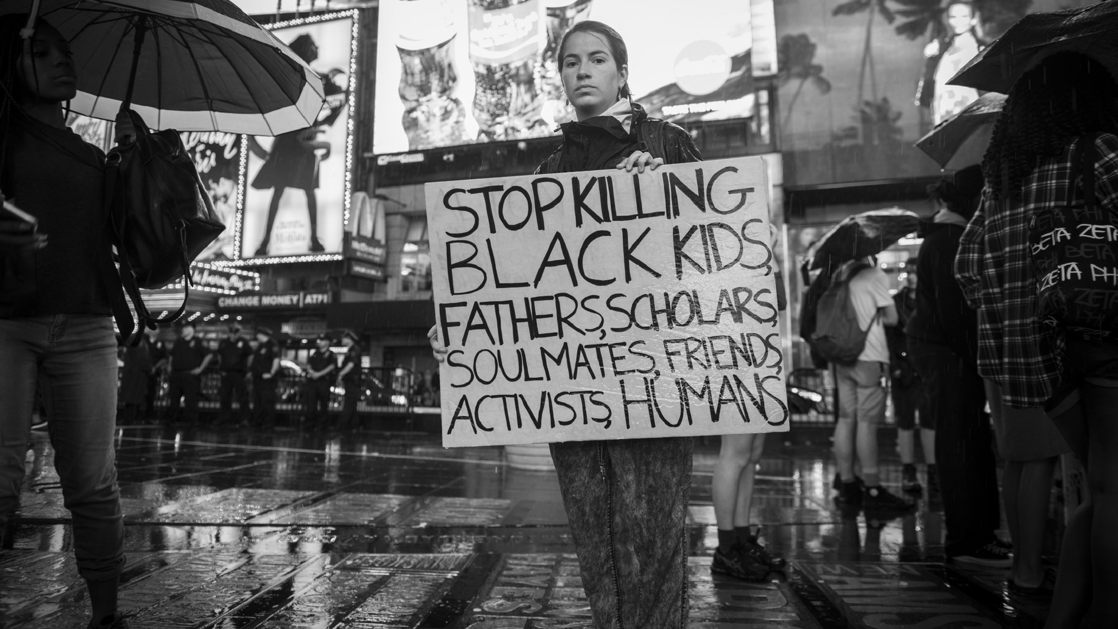 woman-protesting-holding-sign-white-privilege