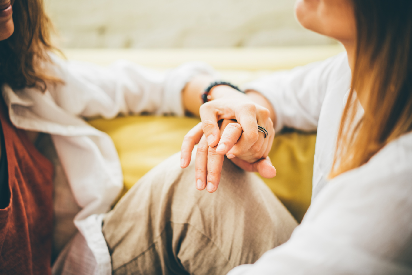 women_holding_hands.png