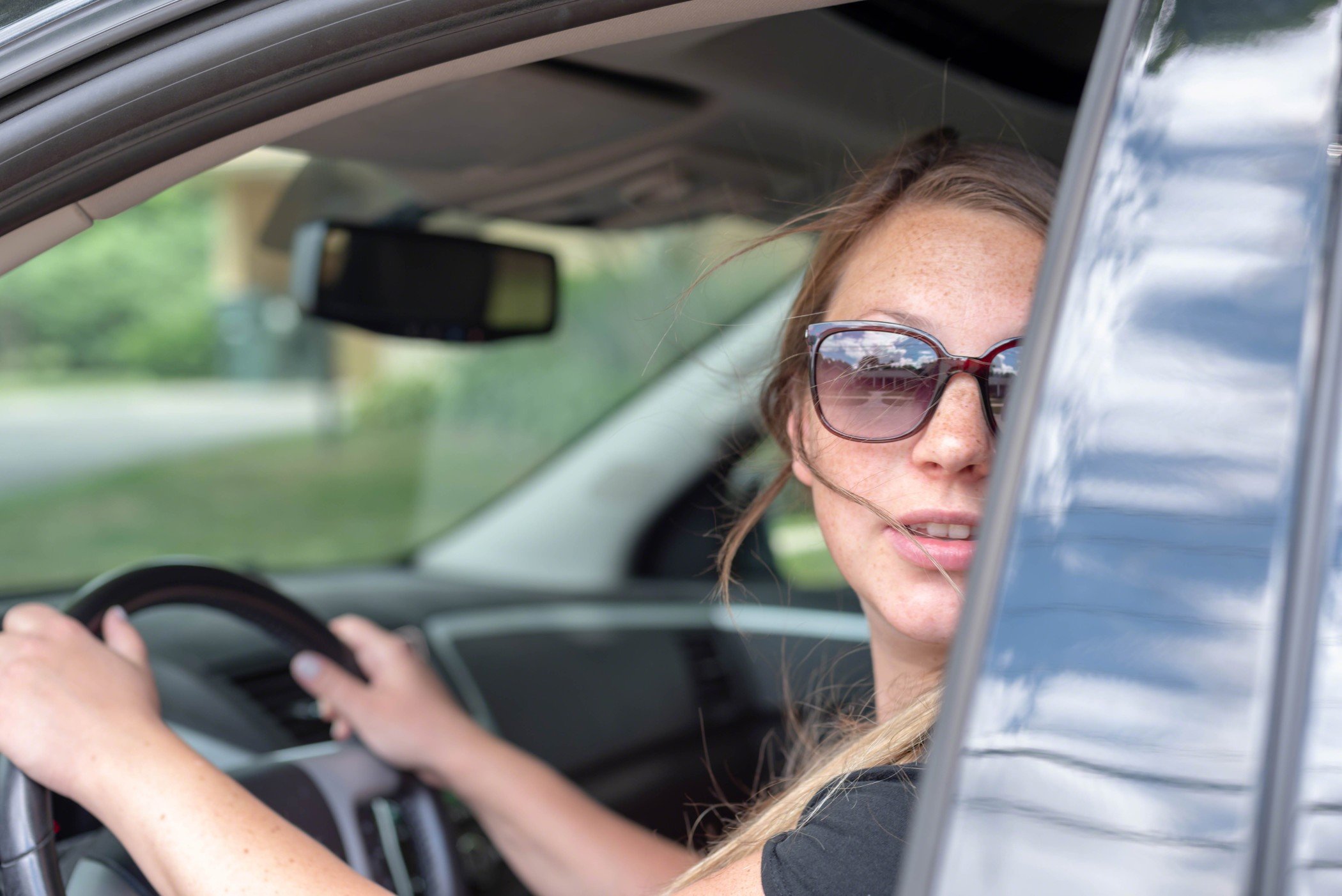 young-millennial-woman-driving-looking-over-shoulder-people-in-cars-drive-commute-on-the-road-drive t20 AlBJmm