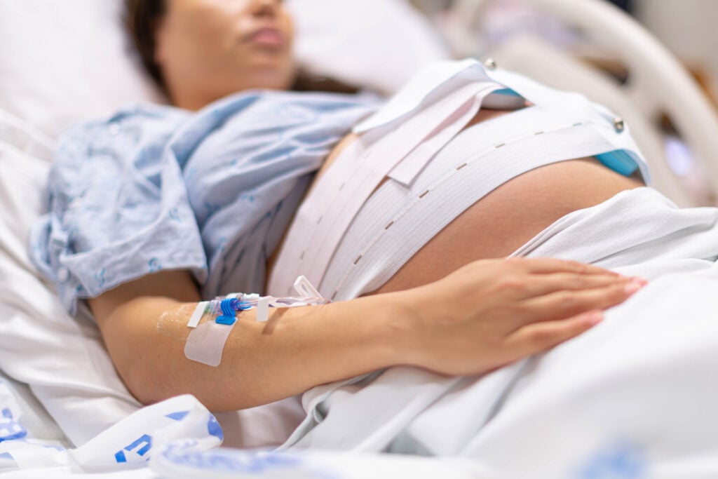 A pregnant woman in the hospital delivery room before giving birth. Childbirth and contractions.