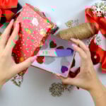 Woman’s hands making a pregnancy test as a Christmas gift. table with New Year’s decorations. View from above. Holiday mood, motherhood