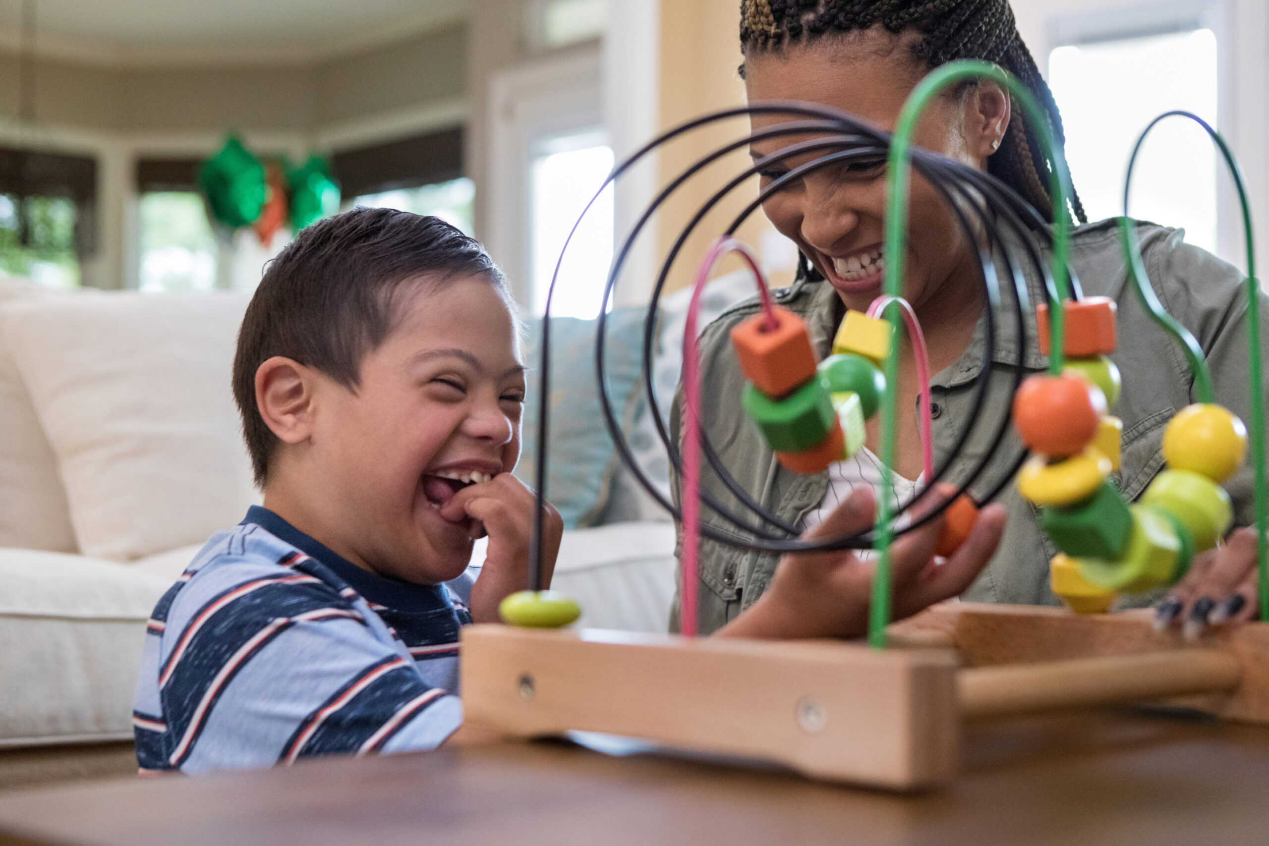 woman playing game with little boy with special needs