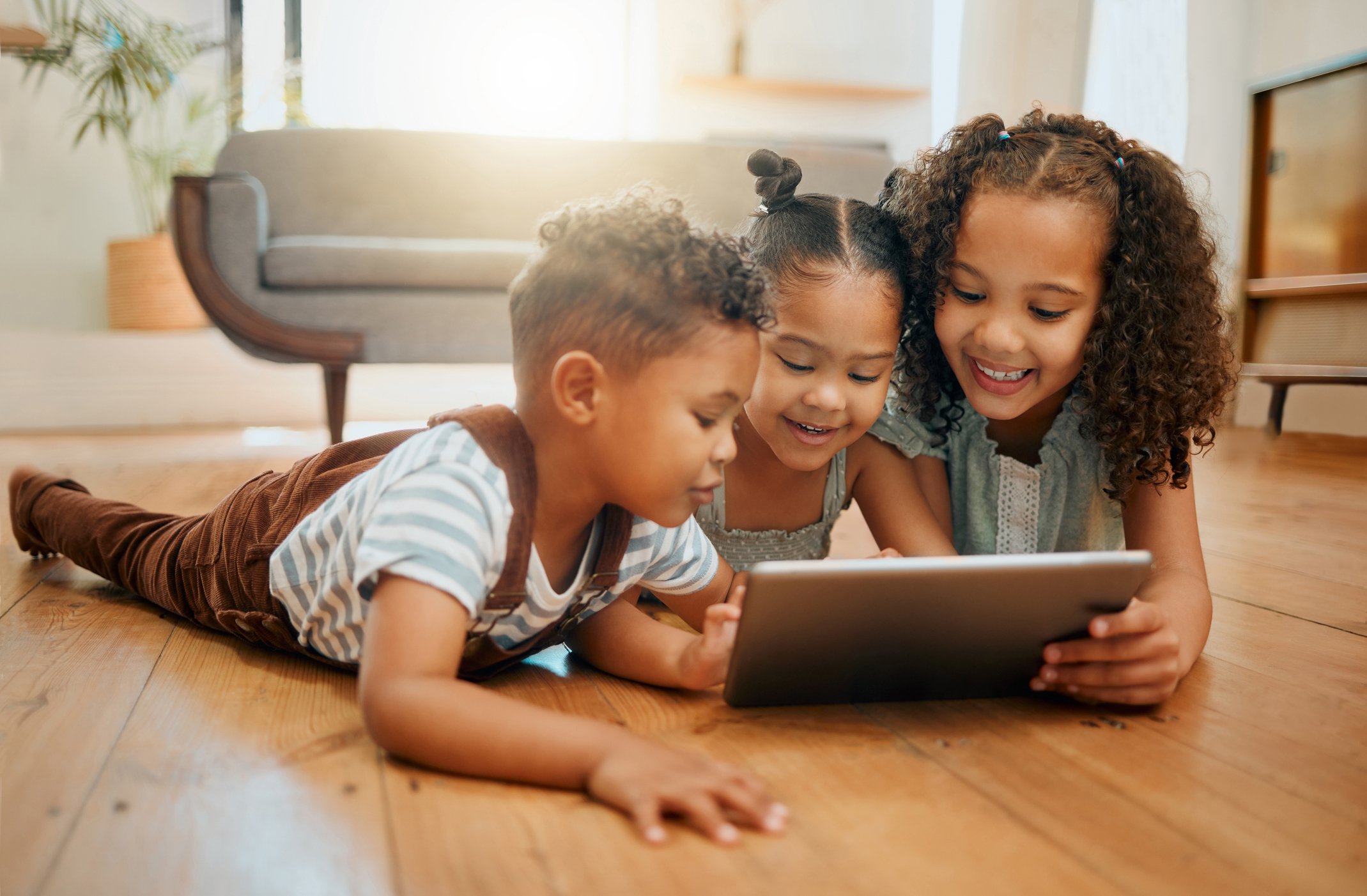 Kids playing on a tablet at home