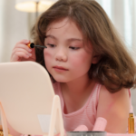 young child doing makeup