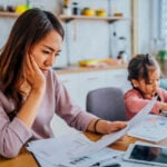 Stressed mother going through her finances